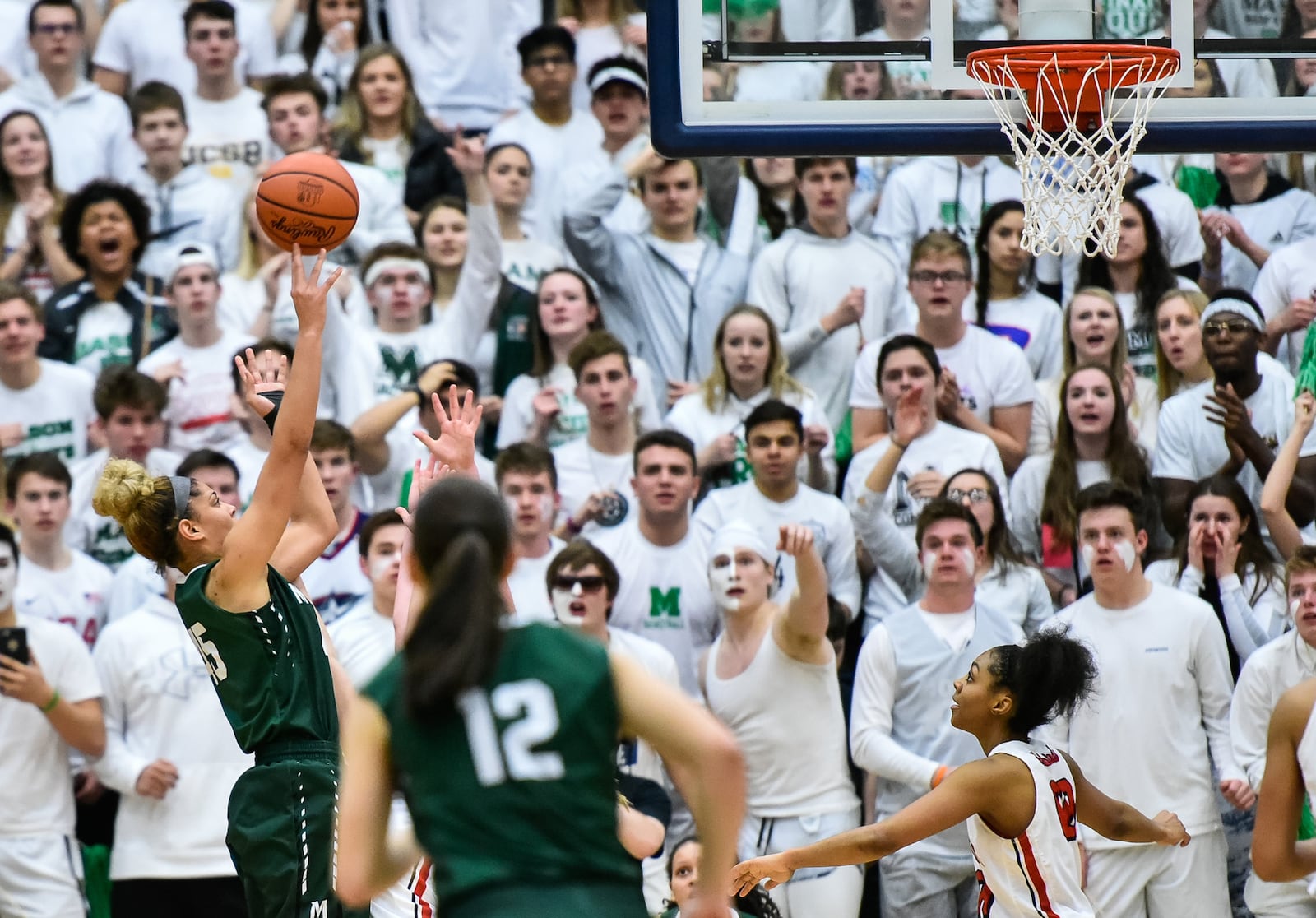 Mason's Tihanna Fulton puts up a shot in front of her school’s student action during Saturday night’s Division I regional final against Lakota West at Fairmont’s Trent Arena. NICK GRAHAM/STAFF