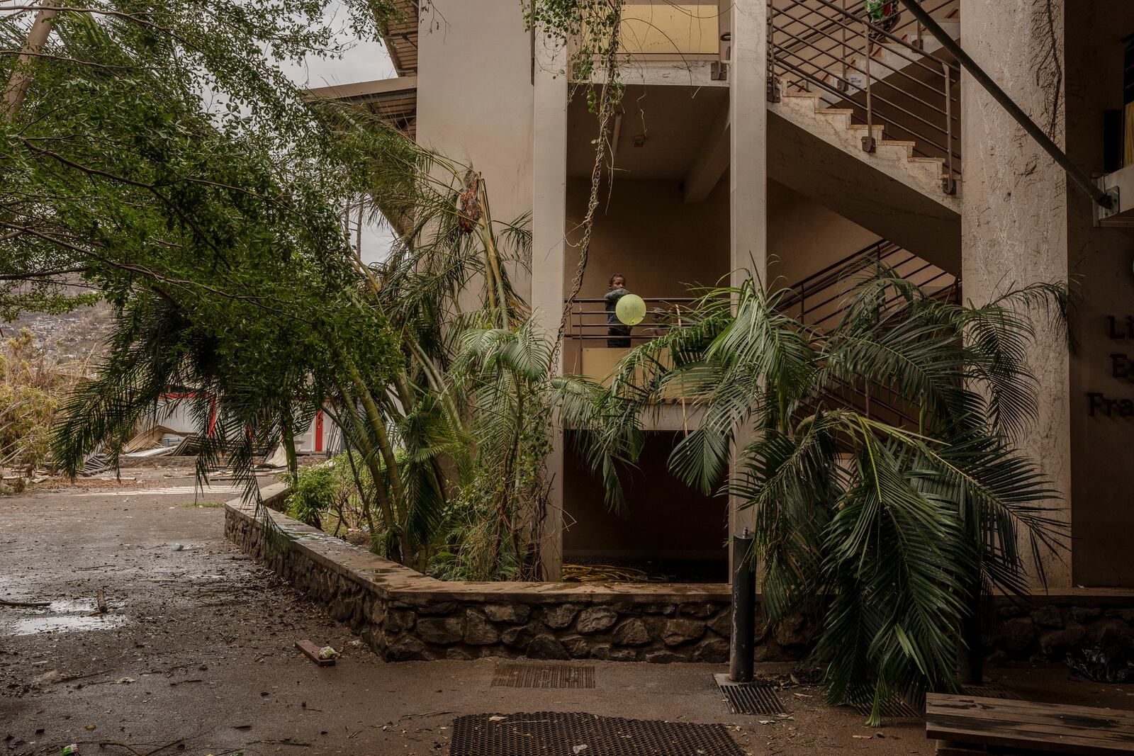 A child plays at the Lycée des Lumières where he found shelter, in Mamoudzou, Mayotte, on Thursday, Dec. 19, 2024. (AP Photo/Adrienne Surprenant)