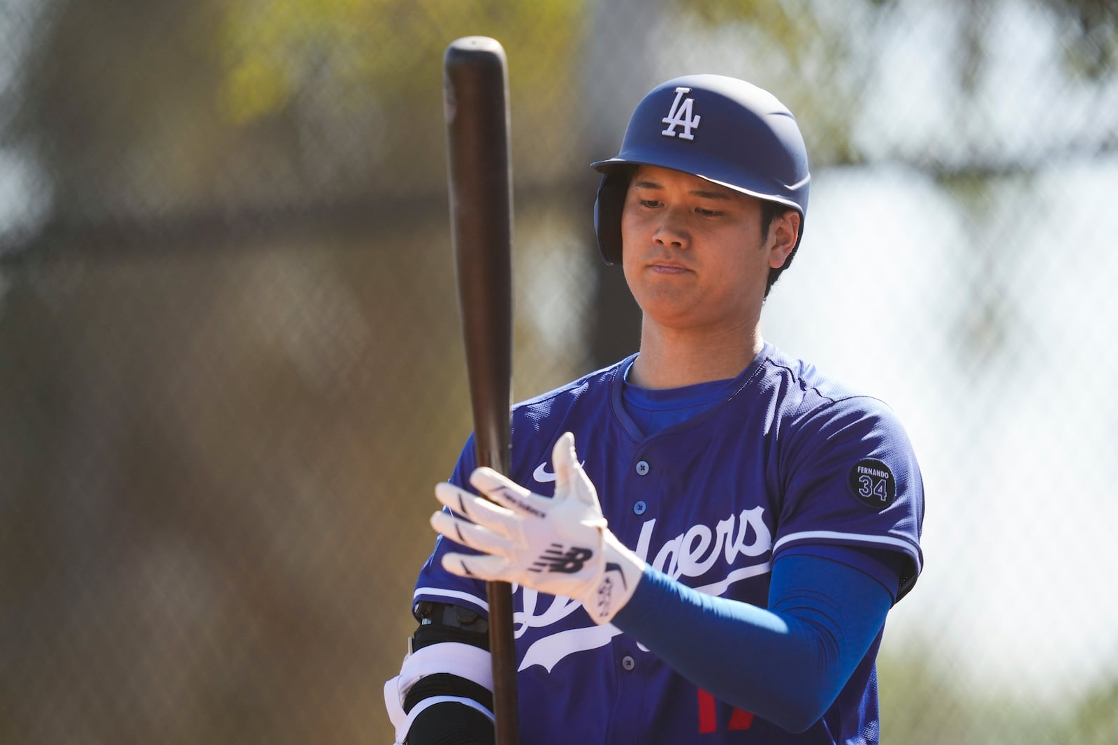 Los Angeles Dodgers two-way player Shohei Ohtani works out during a spring training baseball practice, Wednesday, Feb. 26, 2025, in Phoenix. (AP Photo/Ashley Landis)