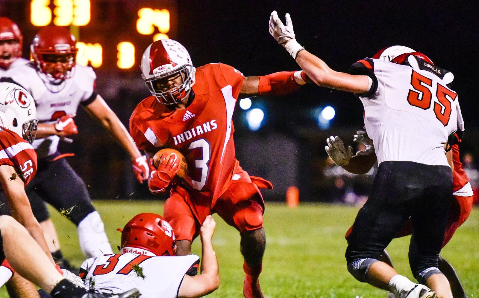 Carlisle’s D.J. Chambers (3) is hounded by Madison’s Tanner Limon (37) and Levi Wilson (55) during an Oct. 6 game at Carlisle’s Laughlin Field. The visiting Mohawks won 31-14. NICK GRAHAM/STAFF