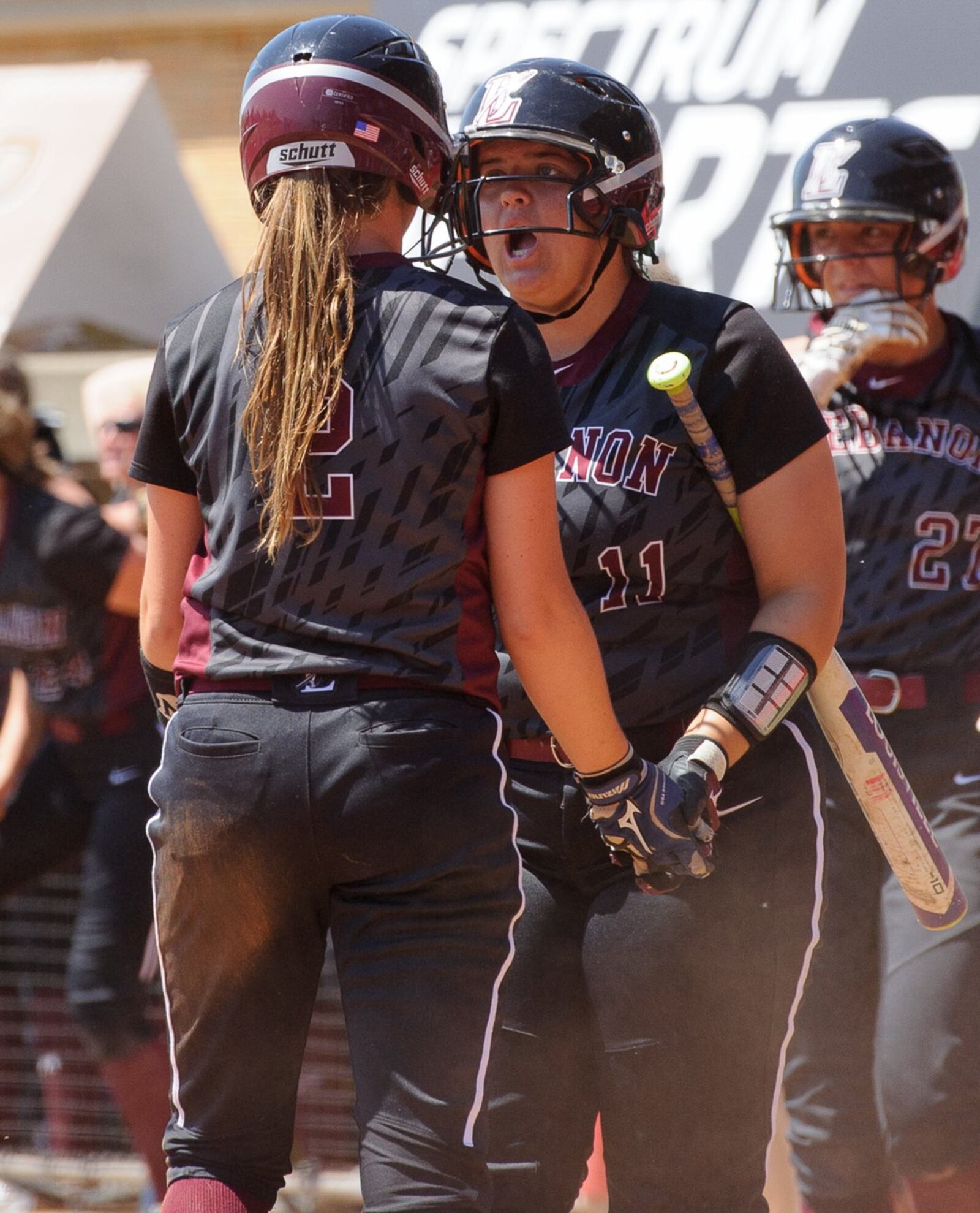 Lebanon’s Alexis Strother (right) greets Kat Frank after Frank scored a run in the seventh inning of the Division I state final against Elyria on Saturday at Firestone Stadium in Akron. CONTRIBUTED PHOTO BY BRYANT BILLING