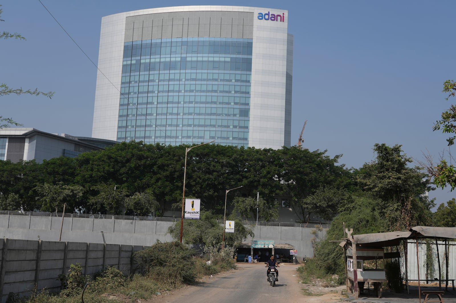 A motorcyclist ride past the Adani's corporate house in Ahmedabad, India, Thursday, Nov. 21, 2024. (AP Photo/Ajit Solanki)