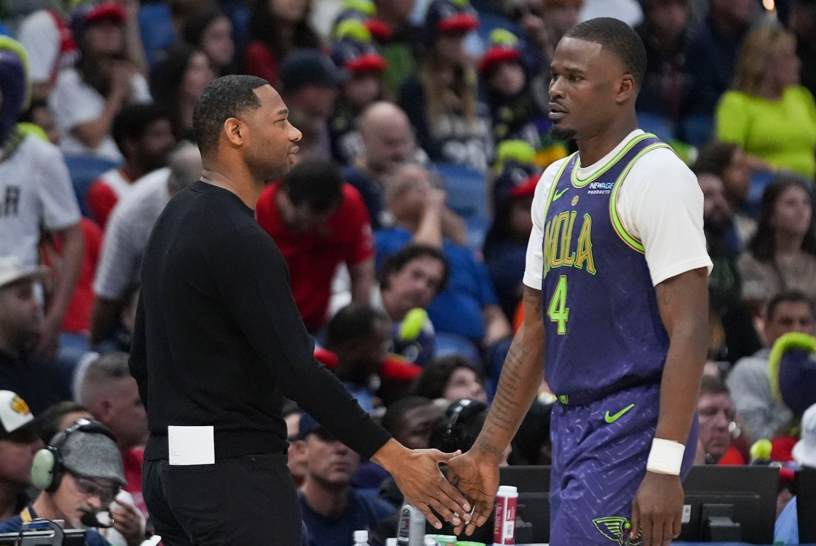 New Orleans Pelicans head coach WIllie Green greets guard Javonte Green (4) as he walks to the bench in the first half of an NBA basketball game against the Toronto Raptors in New Orleans, Wednesday, Nov. 27, 2024. (AP Photo/Gerald Herbert)