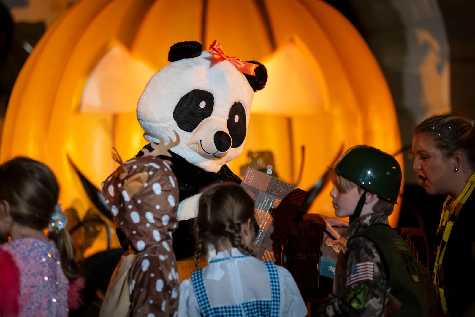 First lady Jill Biden, wearing a panda suit, hosts local area students, military-connected children, and neighborhood families for trick-or-treating, ahead of Halloween on Thursday, at the South Lawn of the White House in Washington Wednesday, Oct. 30, 2024. (AP Photo/Ben Curtis)