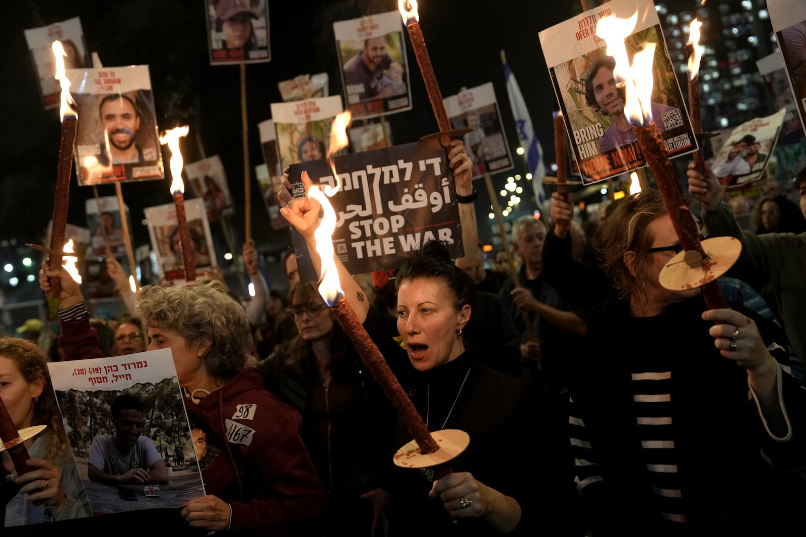 Relatives and friends of people killed and abducted by Hamas and taken into Gaza, react to the ceasefire announcement as they take part in a demonstration in Tel Aviv, Israel, Wednesday, Jan. 15, 2025. (AP Photo/Oded Balilty)