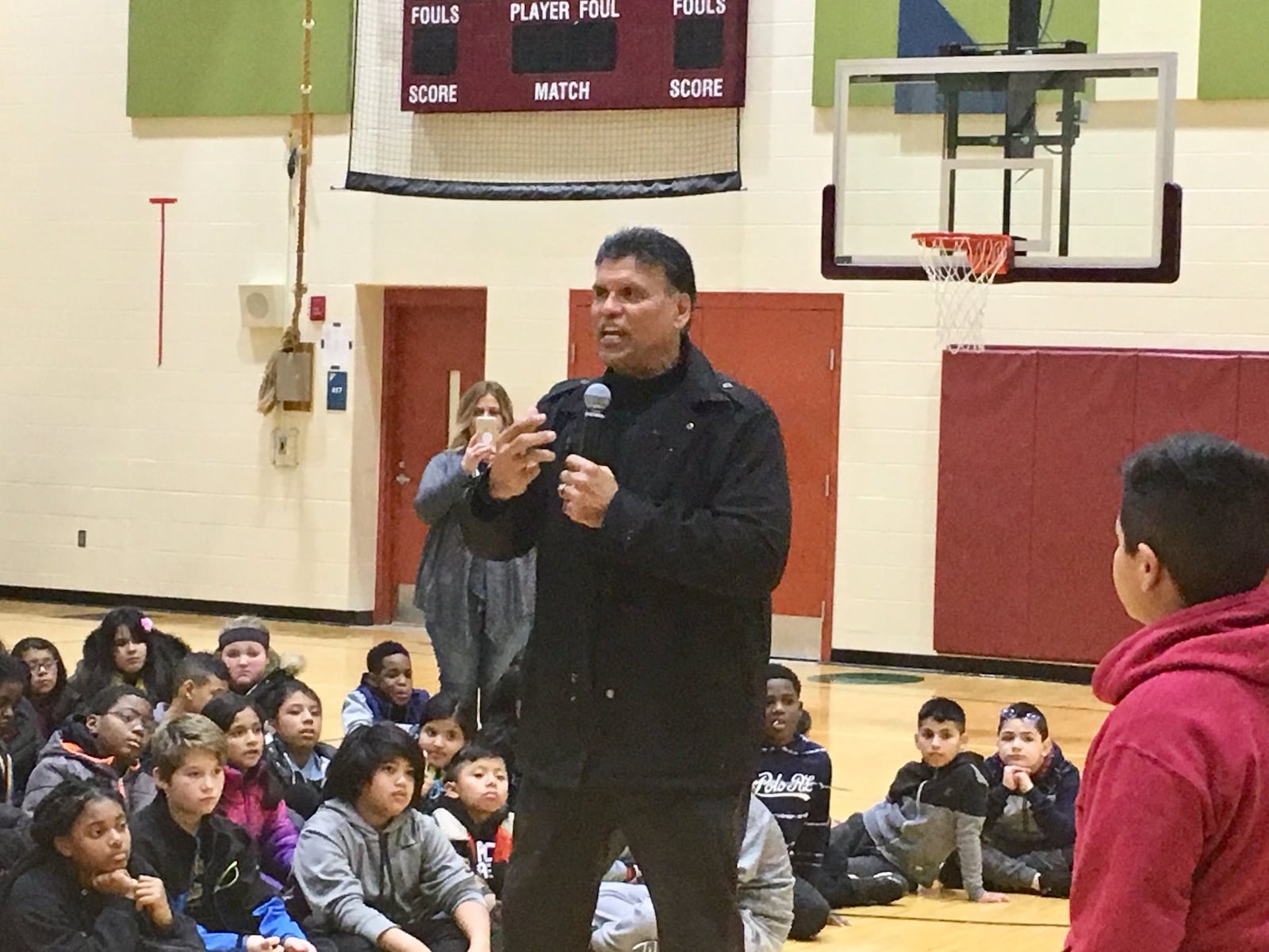 NFL Hall Of Famer Anthony Munoz speaks to some Crawford Woods Elementary students about the importance of character and education Wednesday. Munoz, a former star with the Cincinnati Bengals and a long-time advocate for underprivileged Hispanic students nationwide, was at the Hamilton School to present winter coats to about a dozen boys who recently attended his “Character Camp.”