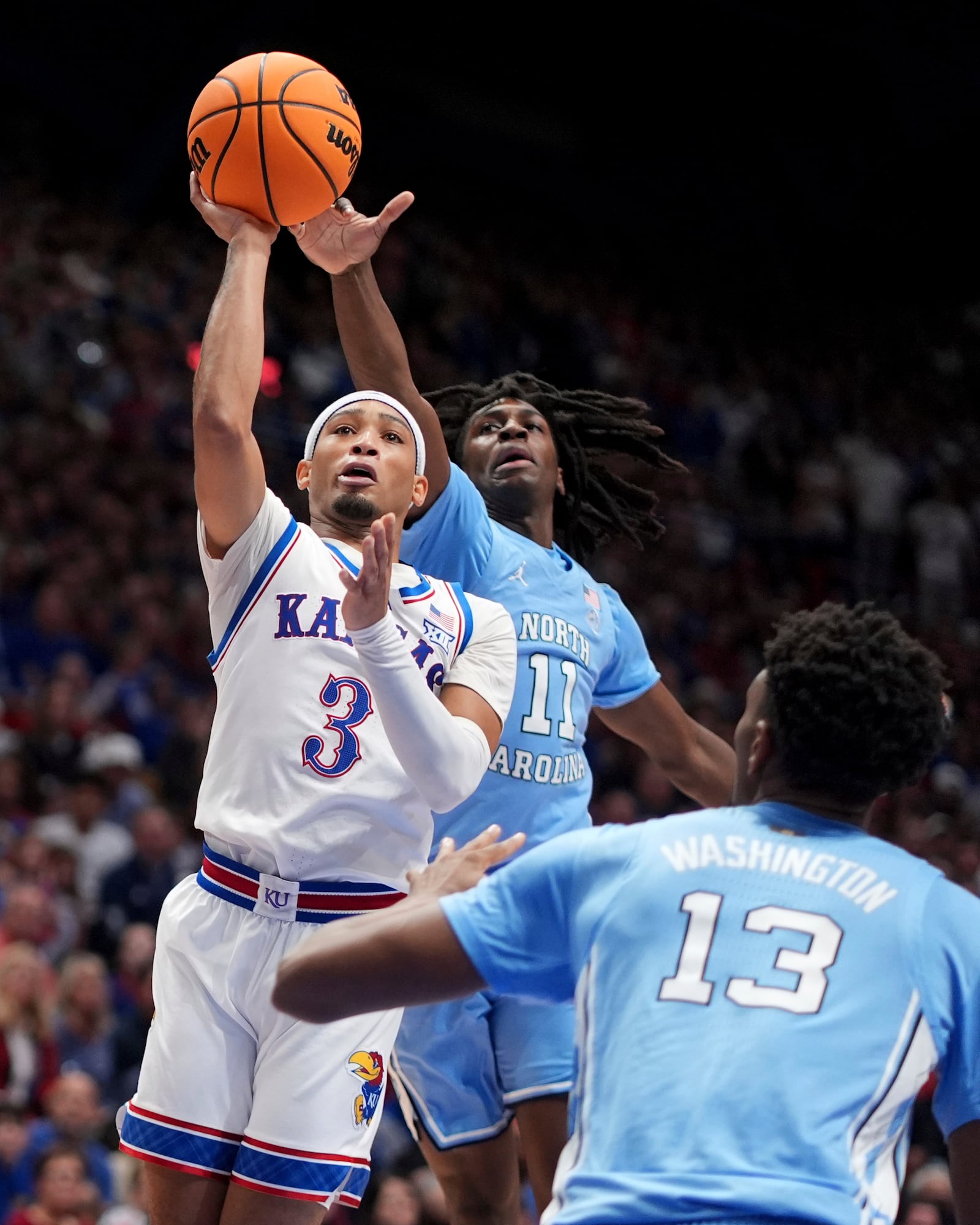 Kansas guard Dajuan Harris Jr. (3) shoots under pressure from North Carolina guard Ian Jackson (11) during the first half of an NCAA college basketball game Friday, Nov. 8, 2024, in Lawrence, Kan. (AP Photo/Charlie Riedel)