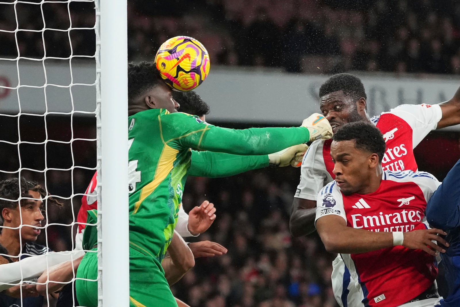 Manchester United's goalkeeper Andre Onana, center, saves a ball during the English Premier League soccer match between Arsenal and Manchester United at Emirates stadium in London, Wednesday, Dec. 4, 2024. (AP Photo/Kirsty Wigglesworth)