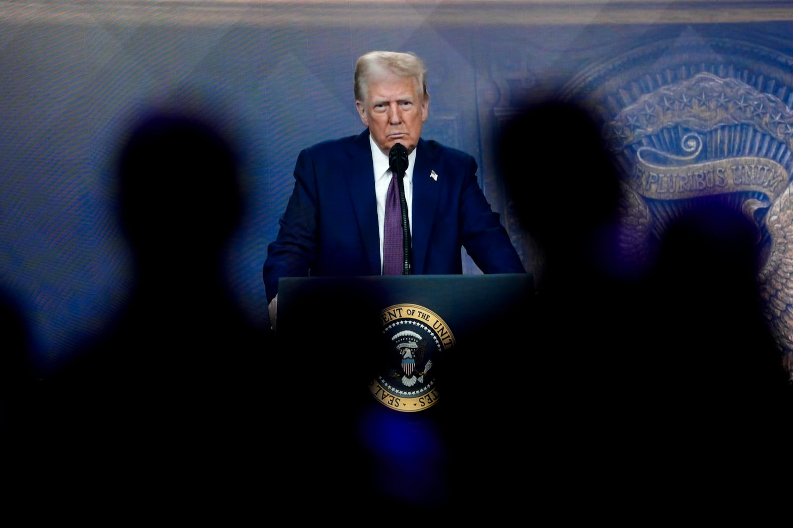 Attendees listen to a virtual speech delivered by U.S. president Donald Trump, at the Annual Meeting of World Economic Forum in Davos, Switzerland, Thursday, Jan. 23, 2025. (AP Photo/Markus Schreiber)