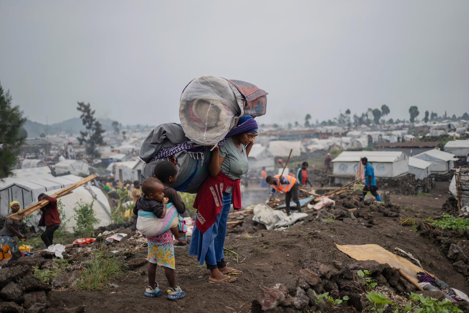 People who were displaced by the fighting between M23 rebels and government soldiers leave their camp following an instruction by M23 rebels in Goma, Democratic Republic of the Congo, Tuesday, Feb. 11, 2025. (AP Photo/Moses Sawasawa)