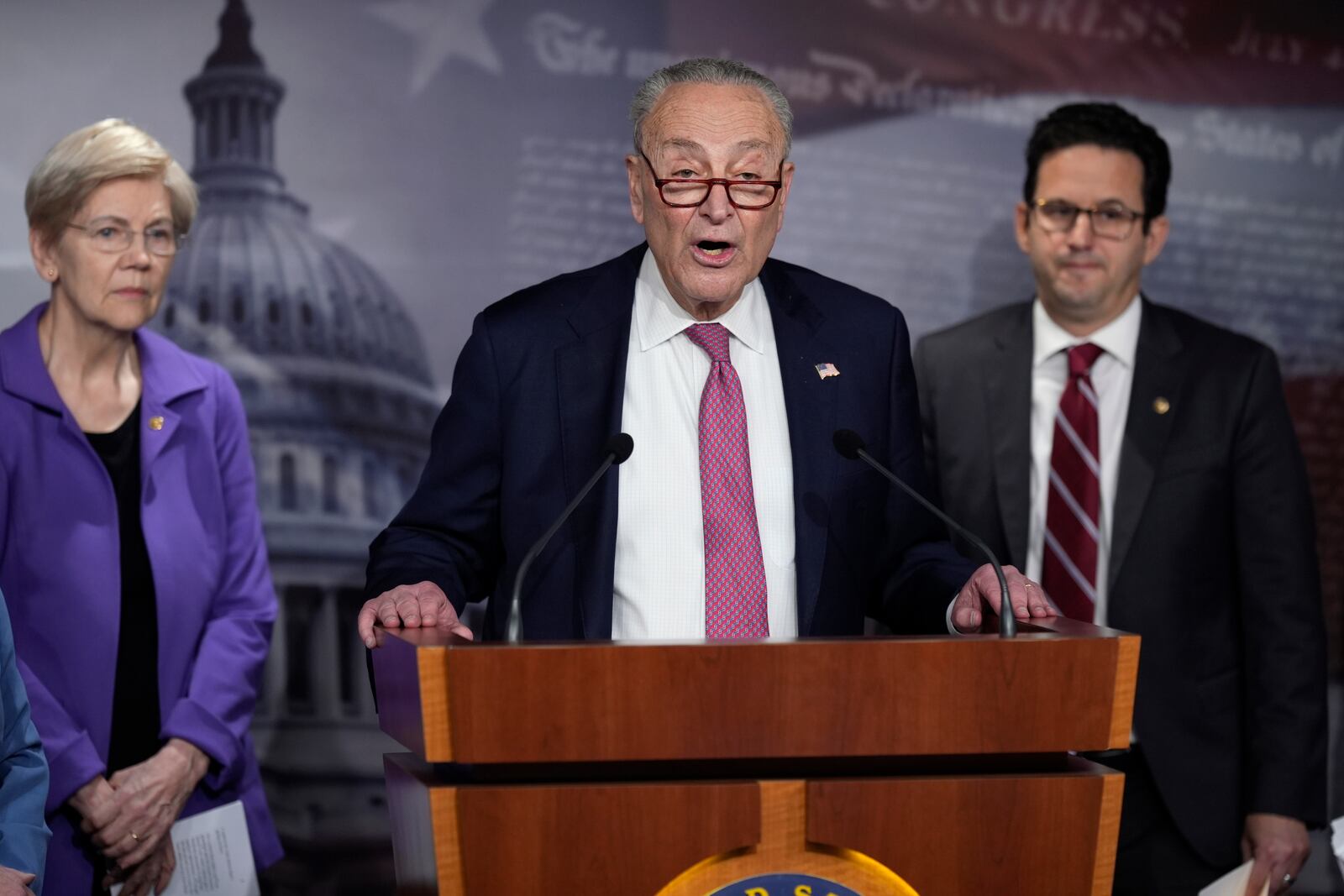 Senate Minority Leader Chuck Schumer, D-N.Y., center, flanked by Sen. Elizabeth Warren, D-Mass., left, and Sen. Brian Schatz, D-Hawaii, speaks about the Department of Government Efficiency, or DOGE, during a news conference at the Capitol in Washington, Monday, Feb. 3, 2025. (AP Photo/J. Scott Applewhite)