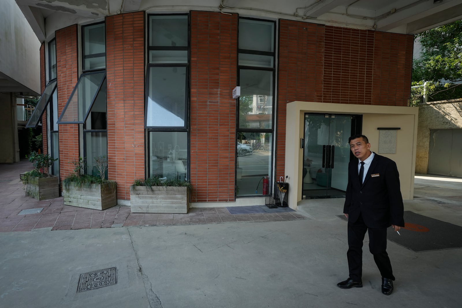 A man stands near what is formerly a branch of the Jiazazhi bookstore in Shanghai, Oct. 10, 2024. (AP Photo/Andy Wong)