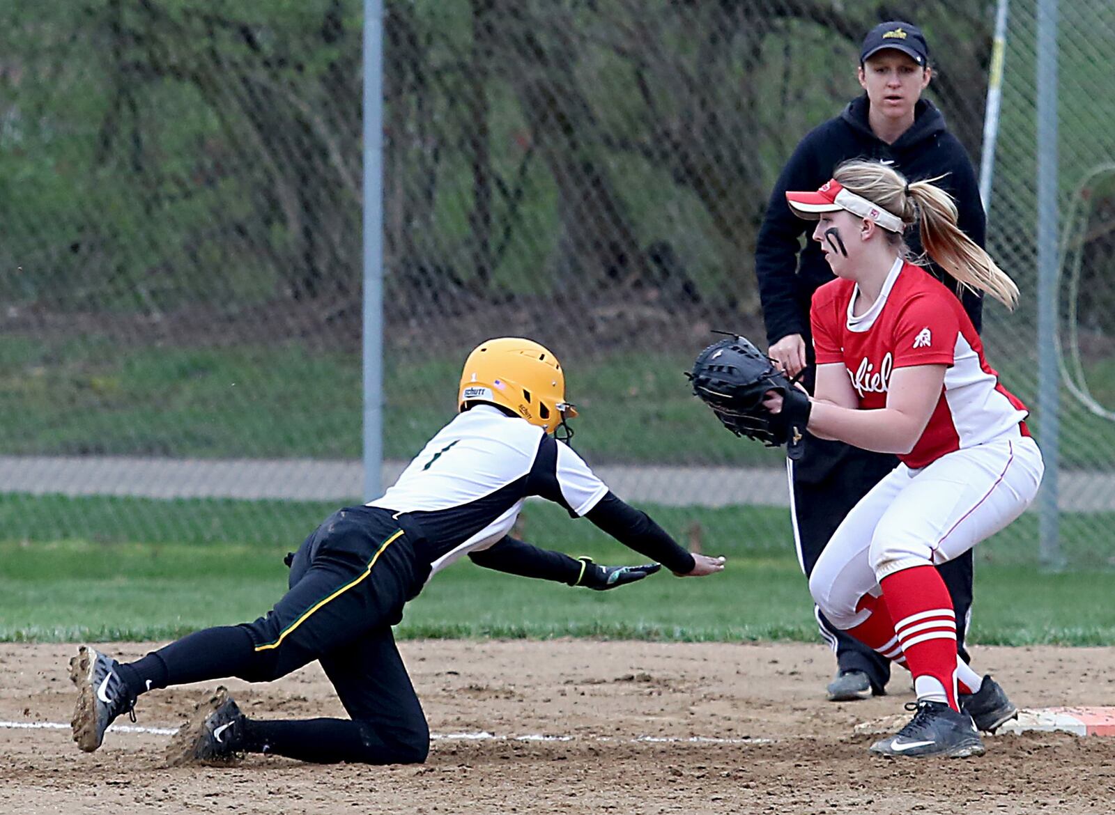 Fairfield first baseman Erin Burdine tries to catch an unidentified Sycamore runner on a pickoff attempt during Tuesday’s game at Fairfield Middle School. CONTRIBUTED PHOTO BY E.L. HUBBARD