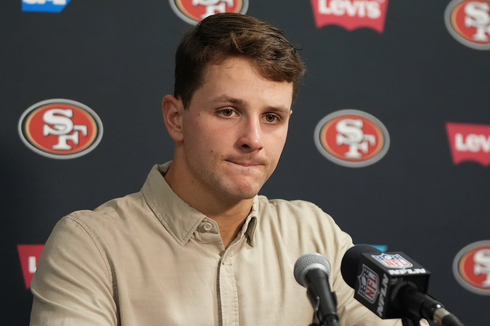 San Francisco 49ers quarterback Brock Purdy (13) reacts to a question during a news conference following an NFL football game against the Miami Dolphins, Sunday, Dec. 22, 2024, in Miami Gardens, Fla.. (AP Photo/Lynne Sladky)