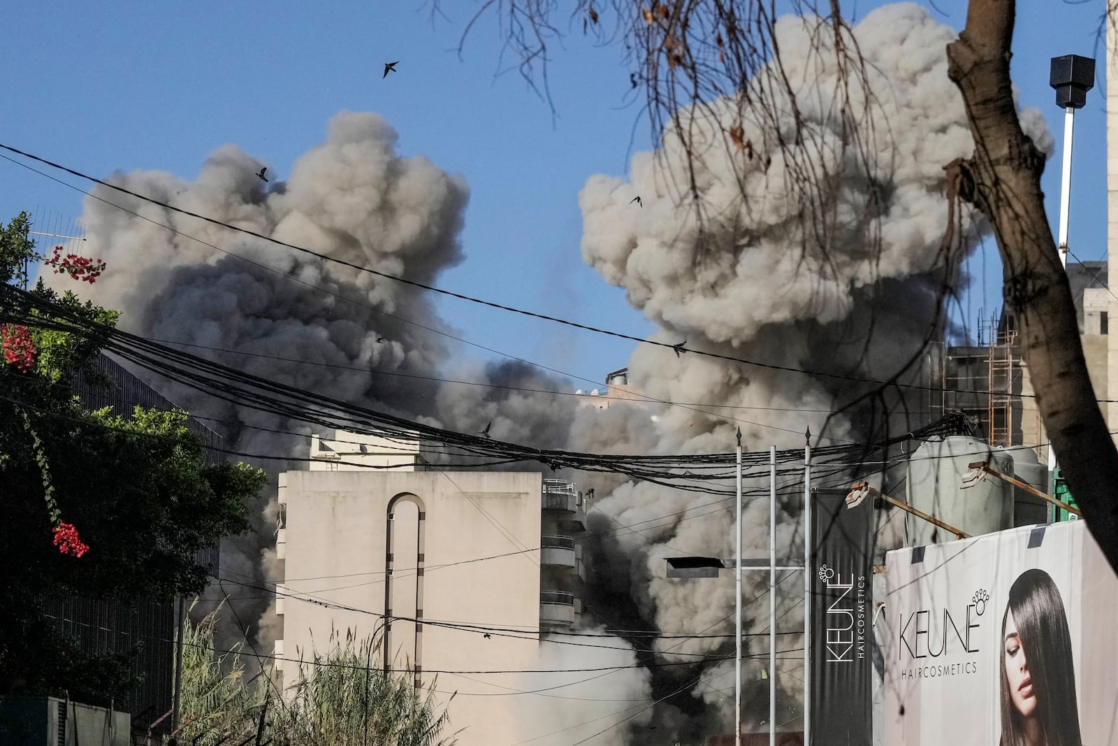 Smoke rises from a building collapsing after it was hit by an Israeli airstrike in Chiyah, south of Beirut, Lebanon, Sunday, Nov. 17, 2024. (AP Photo/Bilal Hussein)