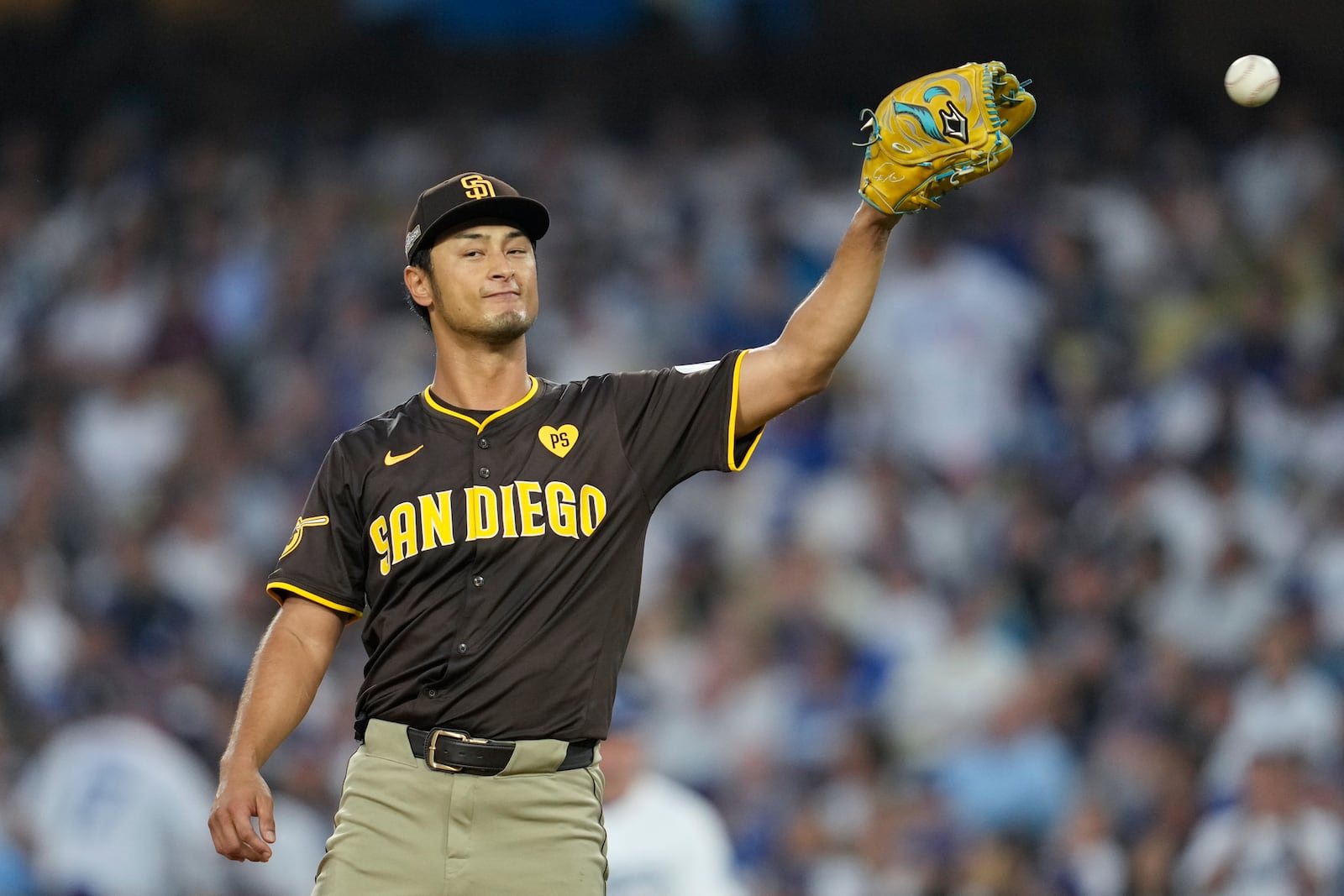 San Diego Padres pitcher Yu Darvish gets a ball back as he pitches during the fifth inning in Game 5 of a baseball NL Division Series against the Los Angeles Dodgers, Friday, Oct. 11, 2024, in Los Angeles. (AP Photo/Ashley Landis)