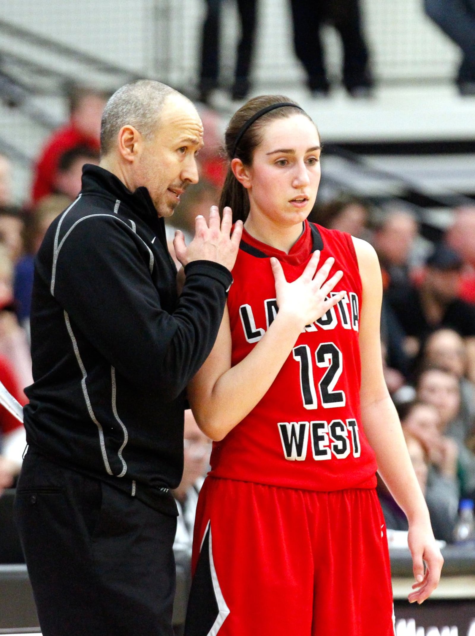 Lakota West head coach Andy Fishman talks with Lauren Cannatelli (12) during a game at Mason on Feb. 24, 2014. JOURNAL-NEWS FILE PHOTO