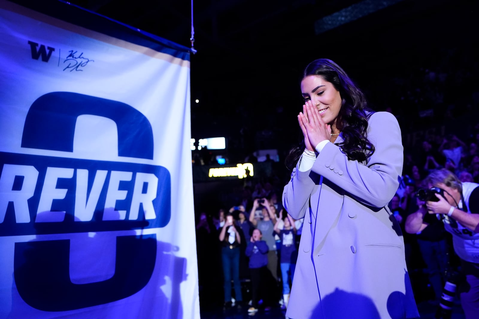 Former Washington guard and current Las Vegas Aces player Kelsey Plum reacts during her jersey retirement ceremony during halftime of an NCAA college basketball game between Washington and Purdue Saturday, Jan. 18, 2025, in Seattle. (AP Photo/Lindsey Wasson)