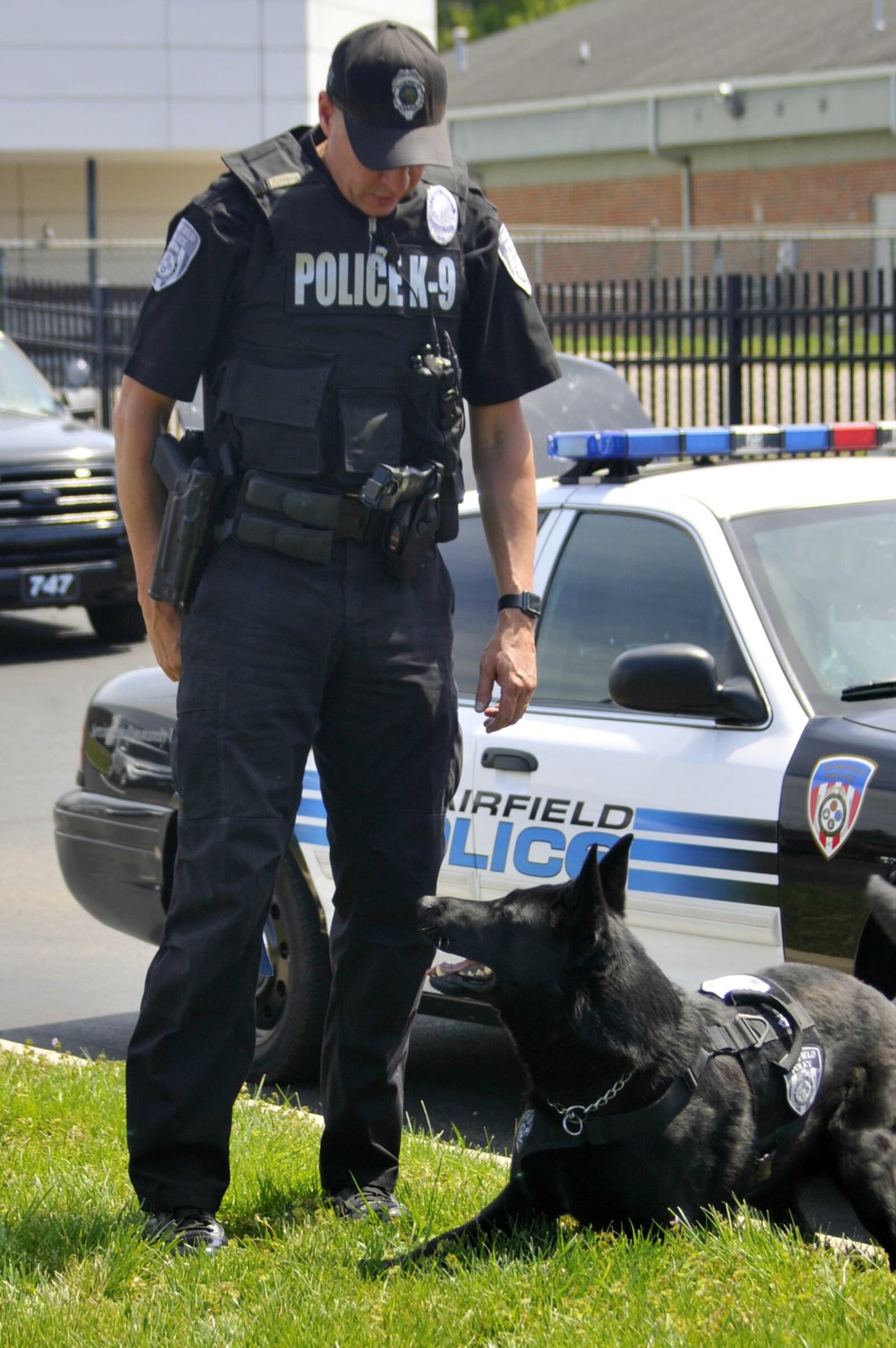 FILE PHOTO 2017: Fairfield police Officer John Cresap interacts with his partner, K9 Officer Canaan, before their shift. MICHAEL D. PITMAN/FILE