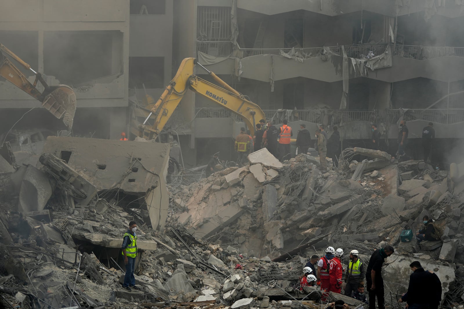 Rescue workers and people search for victims at the site of an Israeli airstrike that hit central Beirut, Lebanon, Saturday, Nov. 23, 2024. (AP Photo/Hassan Ammar)