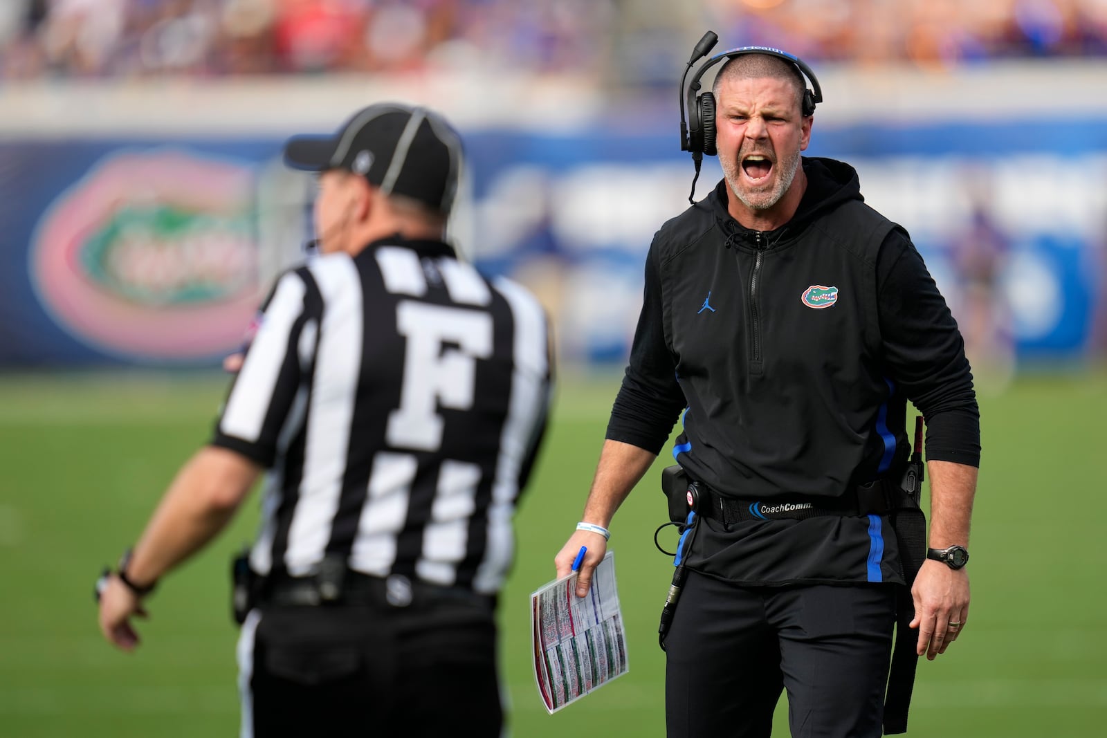 Florida head coach Billy Napier, right, has words with field judge Jay Brown during the first half of an NCAA college football game =aj=, Saturday, Nov. 2, 2024, in Jacksonville, Fla. (AP Photo/John Raoux)