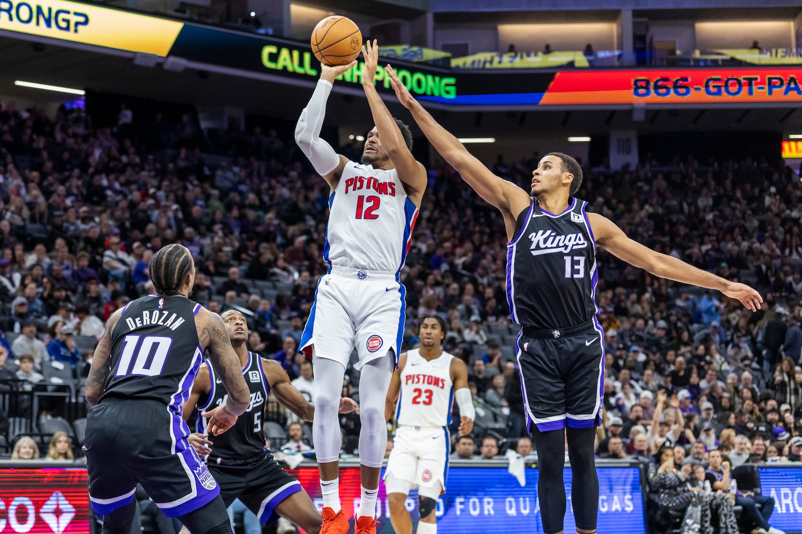 Detroit Pistons forward Tobias Harris (12) goes up to shoot with Sacramento Kings forward Keegan Murray (13) defending during the first half of an NBA basketball game Thursday, Dec. 26, 2024, in Sacramento, Calif. (AP Photo/Sara Nevis)