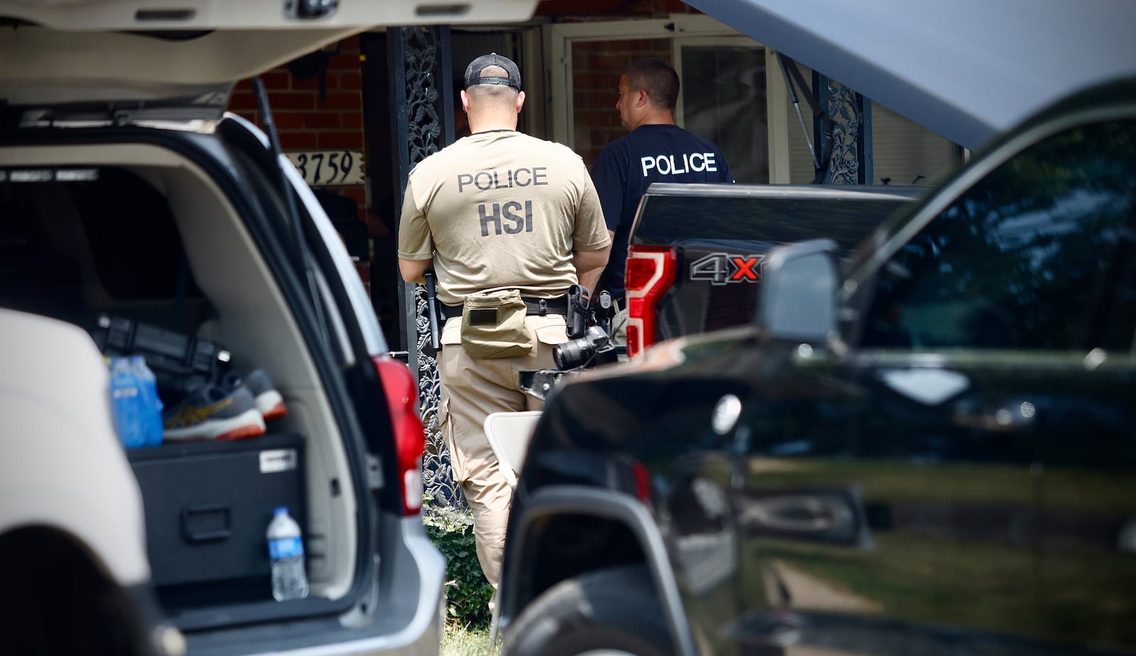 Homeland Security Investigations and Dayton police were outside a residence in the 1100 block of Irving Avenue as part of a federal investigation into allegations of financial crimes and labor exploitation. Search warrants were served at Fuyao Glass America and 27 other locations in the region on Friday, July 26, 2024, as part of the investigation. JIM NOELKER / STAFF