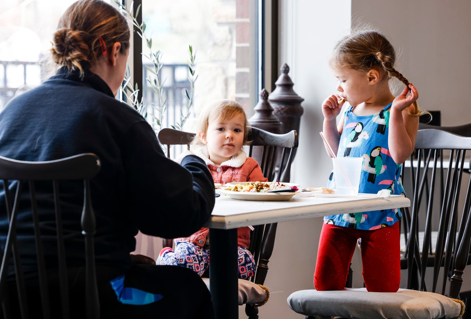 Ashley Demland eats lunch with daughters, Eliza, 4, and Annika, 2, at Al Zaytuna Grill, a new Mediterranean cuisine restaurant, Tuesday, March 29, 2022 at Bridgewater Falls in Fairfield Township. NICK GRAHAM/STAFF