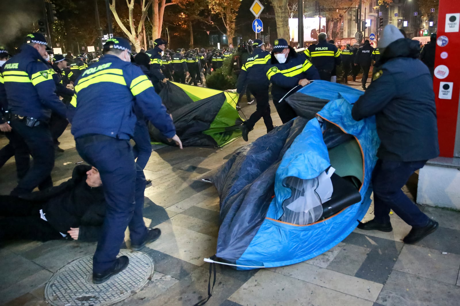 Police remove protesters’ tent camp on a street during a rally against the results of the parliamentary elections amid allegations that the vote was rigged in Tbilisi, Georgia, on Tuesday, Nov. 19, 2024. (AP Photo/Zurab Tsertsvadze)