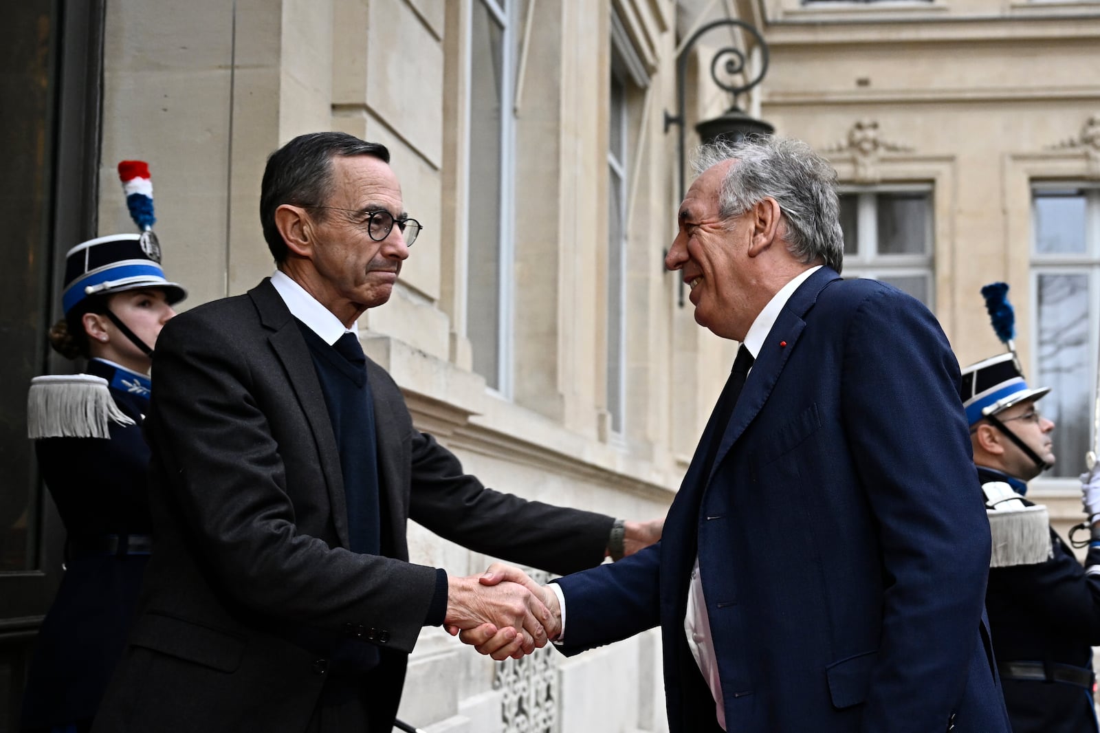 French Minister of the Interior Bruno Retailleau, left, welcomes French Prime Minister Francois Bayrou to attend a meeting at the Interior Ministry in Paris, Monday Dec. 23, 2024, following the cyclone Chido's passage over the French Indian Ocean territory of Mayotte. Hard-right Bruno Retailleau stays on as interior minister, with responsibility for France's security and migration policy. (Julien de Rosa, Pool via AP)