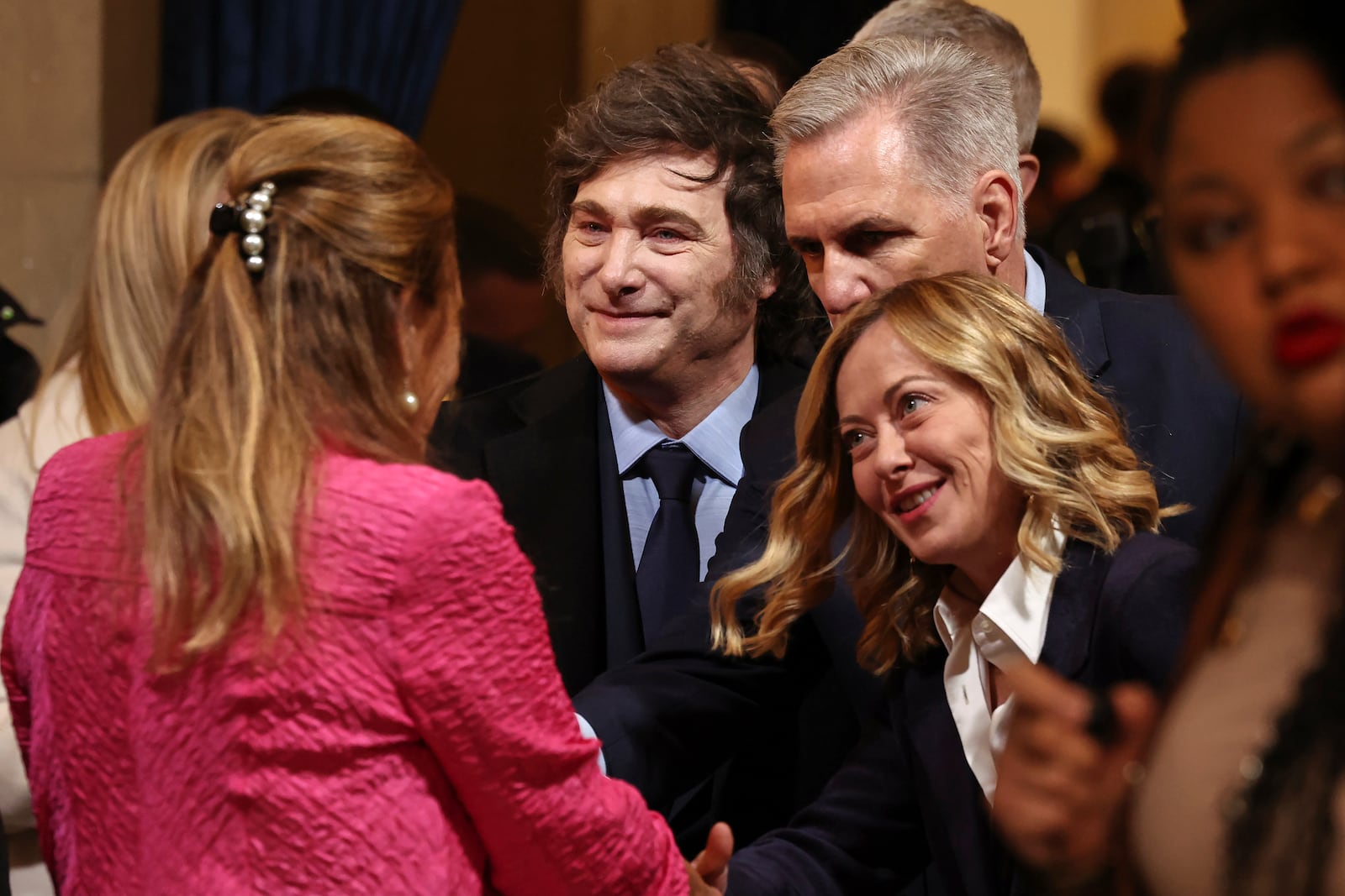 Argentina's President Javier Milei, center, former Speaker of the House Kevin McCarthy, top right, and Italian Premier Giorgia Meloni arrive before the 60th Presidential Inauguration in the Rotunda of the U.S. Capitol in Washington, Monday, Jan. 20, 2025. (Chip Somodevilla/Pool Photo via AP)