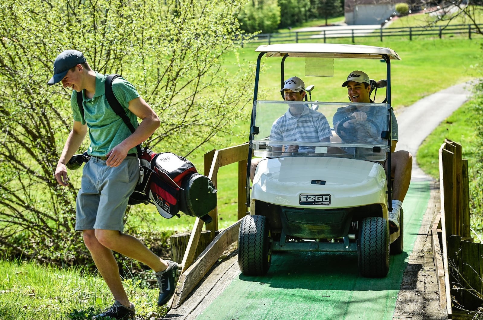 Kenny Pendergest, 17, makes his way across a bridge trailed by Nathan Schuster, 16, right, and Sean Pendergest, 15, during a round of golf at Potter’s Park Golf Course Tuesday, May 1 in Hamilton. NICK GRAHAM/STAFF