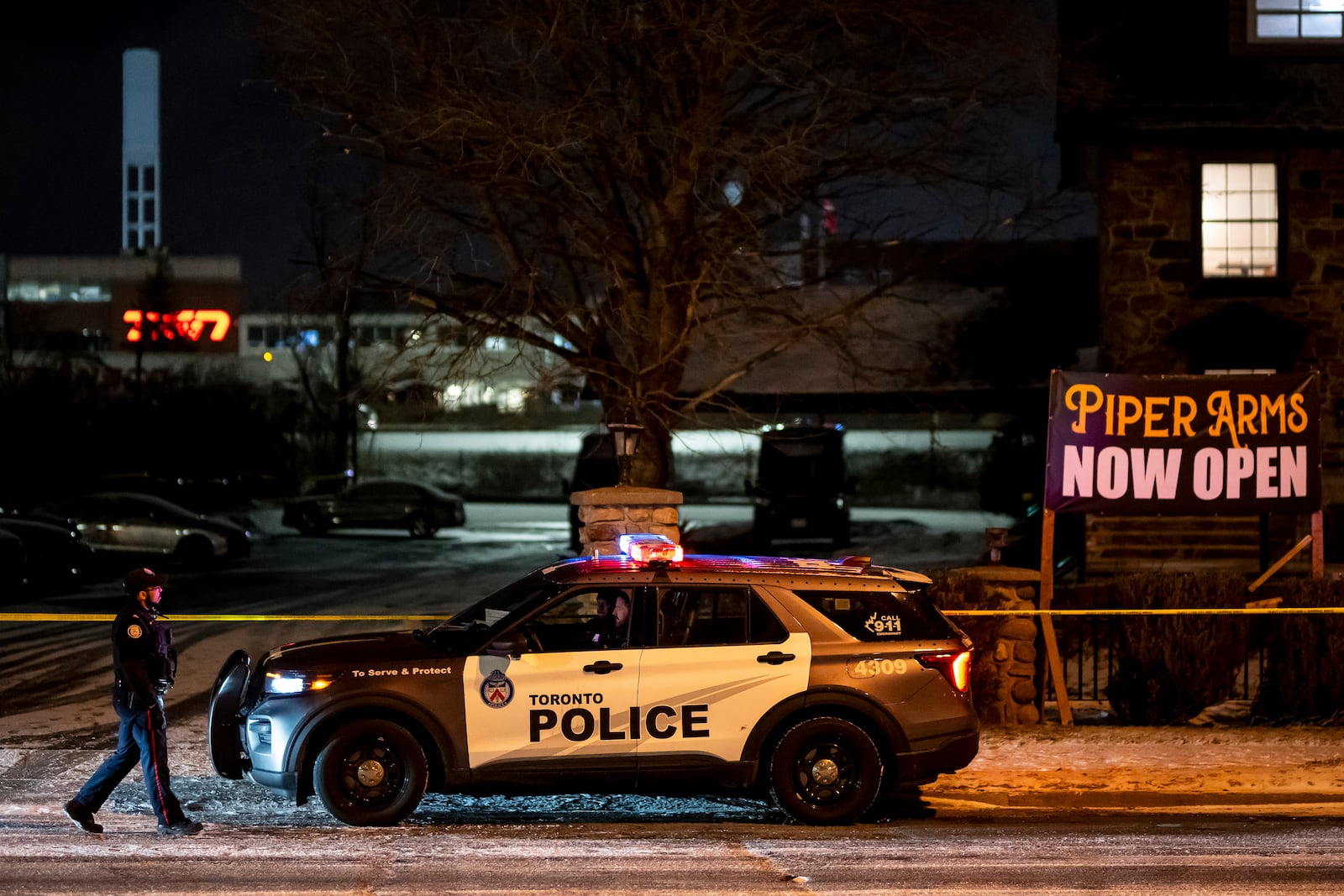 Toronto Police investigate a shooting at the Piper Arms Pub near the Scarborough Town Centre in Toronto on Saturday, March 8, 2025. (Christopher Katsarov/The Canadian Press via AP)