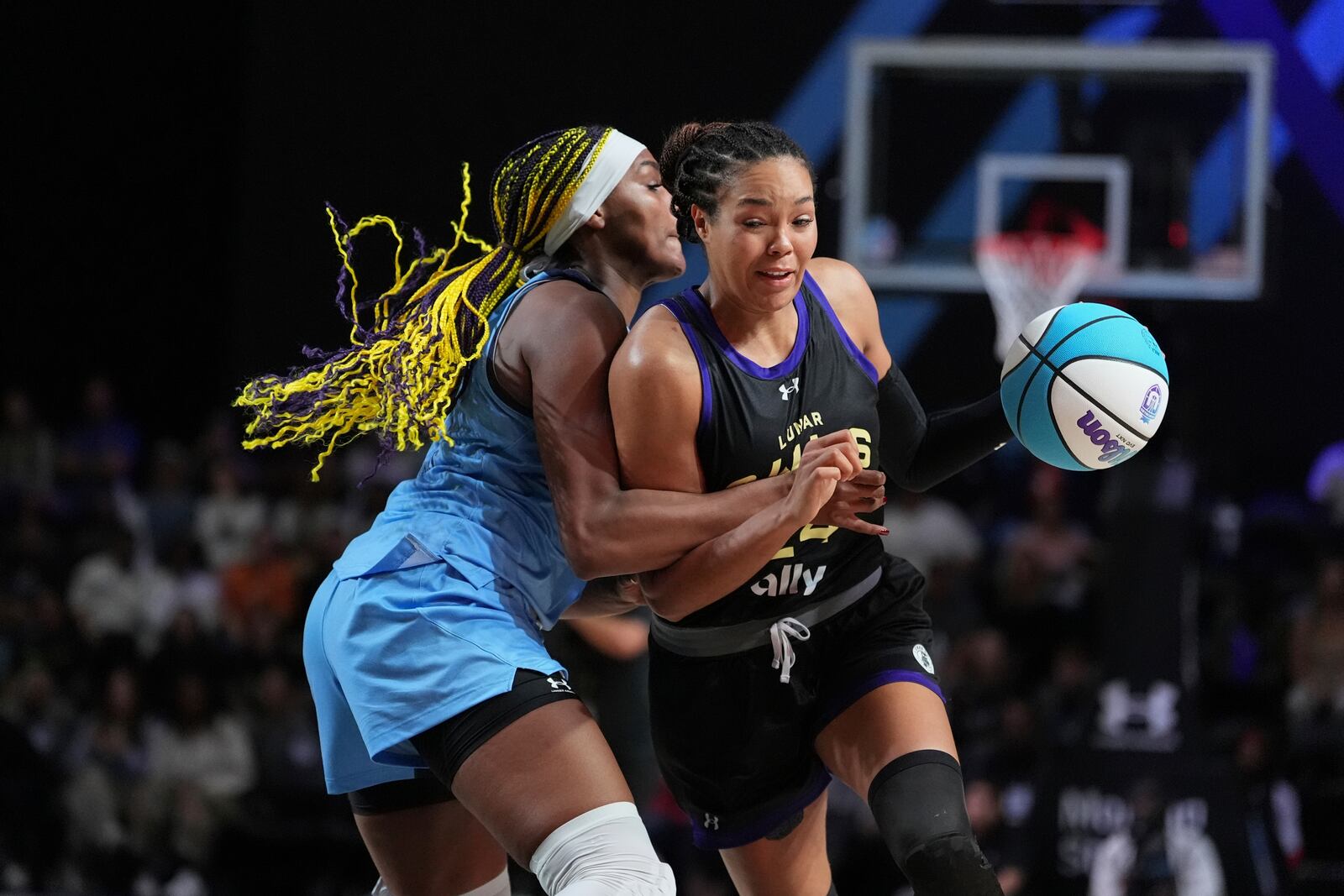 Napheesa Collier, right, drives past Aaliyah Edwards on her way to winning the Unrivaled 1-on-1 basketball final, in Friday, Feb. 14, 2025, in Medley, Fla. (AP Photo/Rebecca Blackwell)