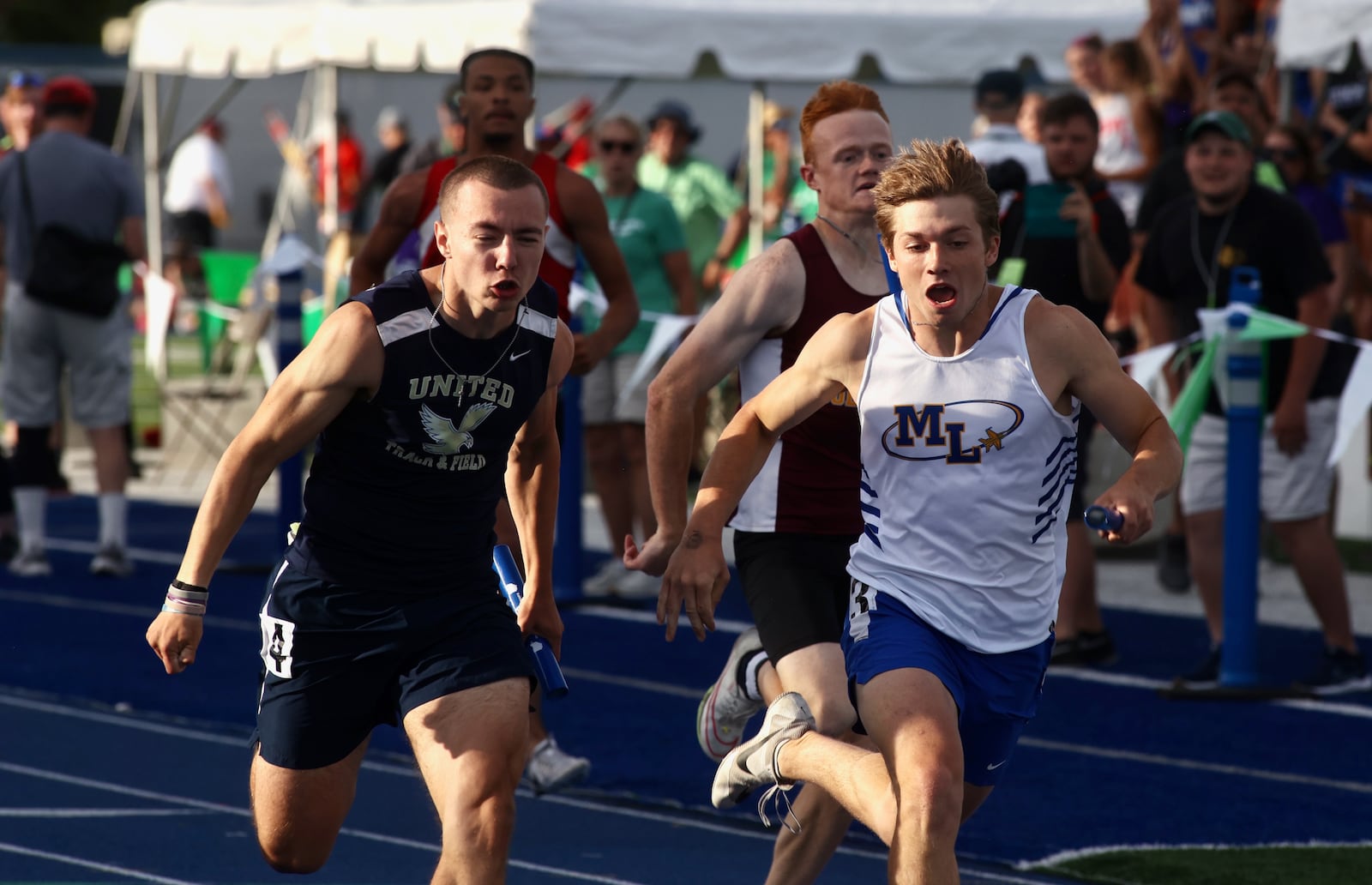 Marion Local's Carter Jones, right, and United's Carter Winburn cross the finish line n the 4x100 relay at the OHSAA Division III state track and field championships on Friday, May 31, 2024, at Welcome Stadium in Dayton. United won in a photo finish. David Jablonski/Staff