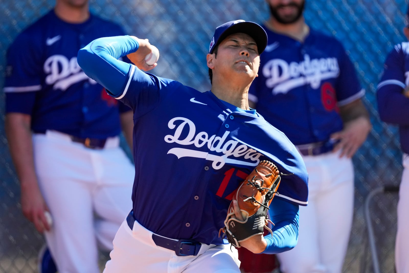 Los Angeles Dodgers two-way player Shohei Ohtani (17) works out during spring training baseball practice, Saturday, Feb. 15, 2025, in Phoenix. (AP Photo/Ashley Landis)