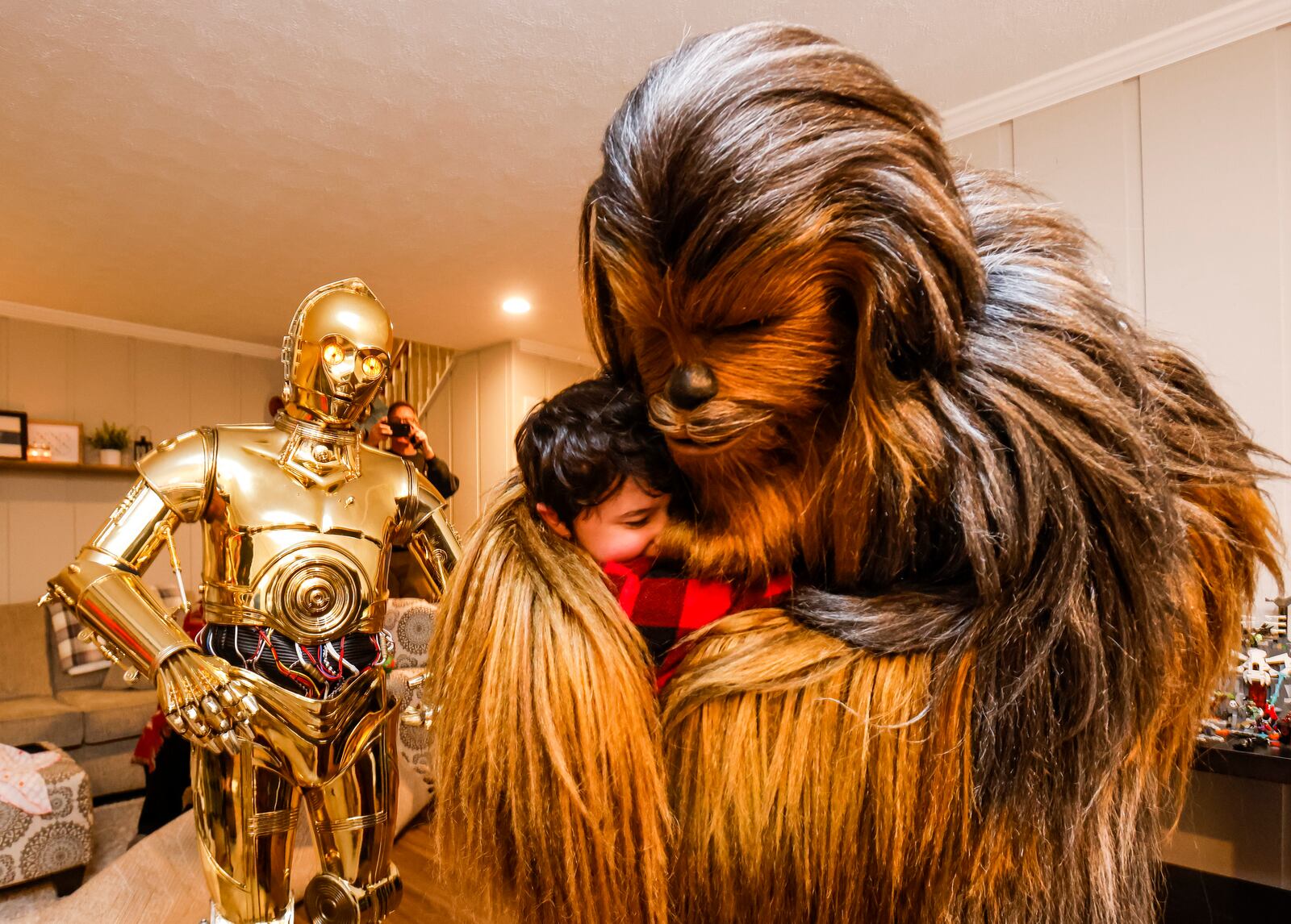 Porter Sowards, a 10-year-old who is battling brain cancer, was surprised with a visit from Star Wars characters, C3PO, portrayed by Tim O'Sullivan, R2D2 and Chewbacca, portrayed by Joey Arielle, at his home Friday, Nov. 12, 2021 in Middletown. Team Fastax also presented Porter and his family with a Dreams of Fastrax certificate for a plane ride and indoor wind tunnel session. NICK GRAHAM / STAFF