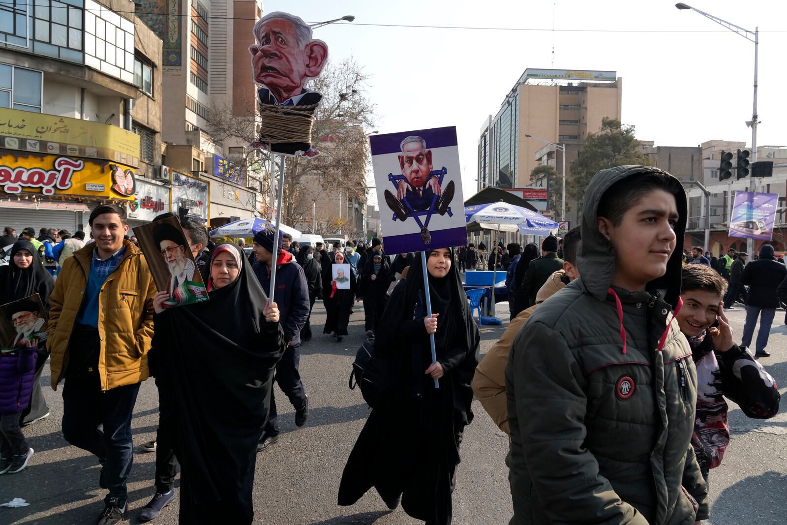 Iranian demonstrators carry caricatures of the Israeli Prime Minister Benjamin Netanyahu during a rally commemorating anniversary of 1979 Islamic Revolution that toppled the late pro-U.S. Shah Mohammad Reza Pahlavi and brought Islamic clerics to power, in Tehran, Iran, Monday, Feb. 10, 2025. (AP Photo/Vahid Salemi)