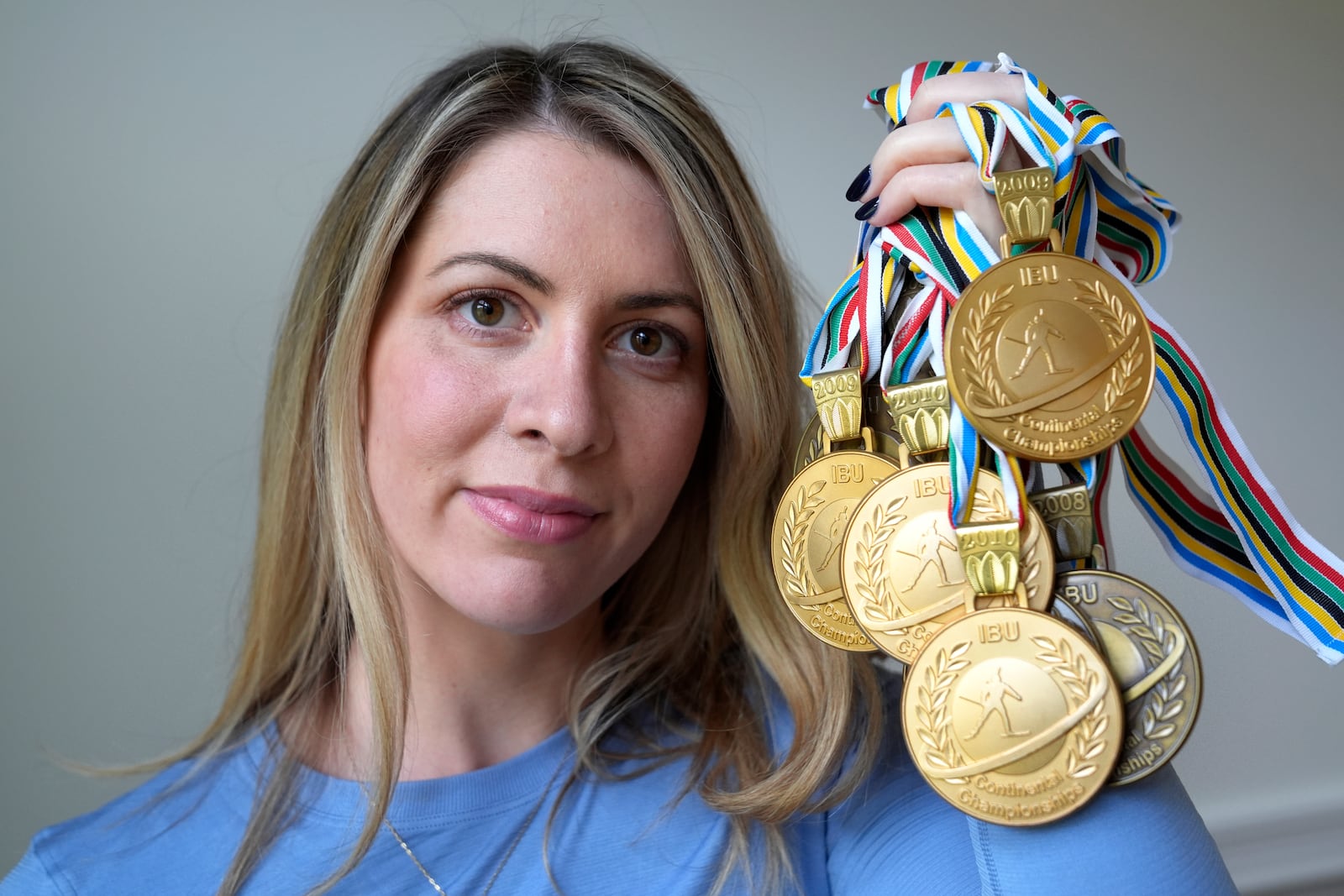 Grace Boutot, who won a silver medal in the Youth World Championships in 2009, displays a few of her medals from competitions, Oct. 17, 2024, at her home in Boston. (AP Photo/Steven Senne)