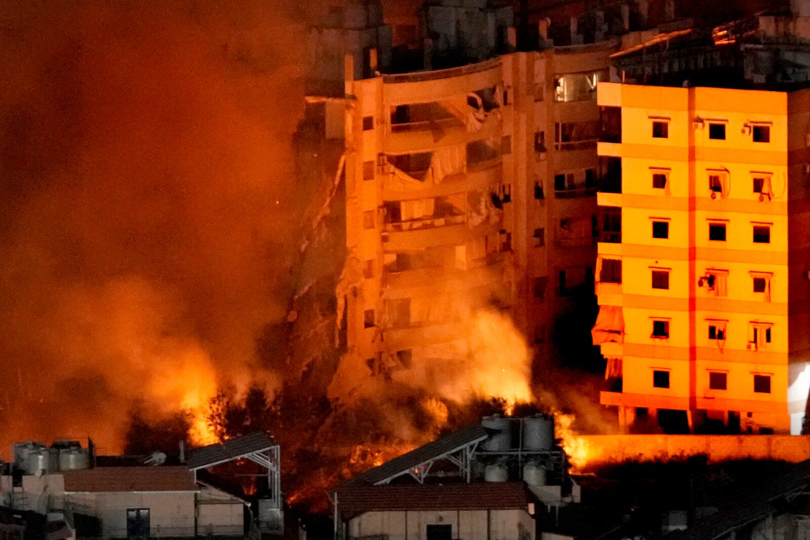 Flame and smoke rise from buildings hit by Israeli airstrikes on Dahiyeh, in the southern suburb of Beirut, Lebanon, Wednesday, Oct. 23, 2024. (AP Photo/Hussein Malla)