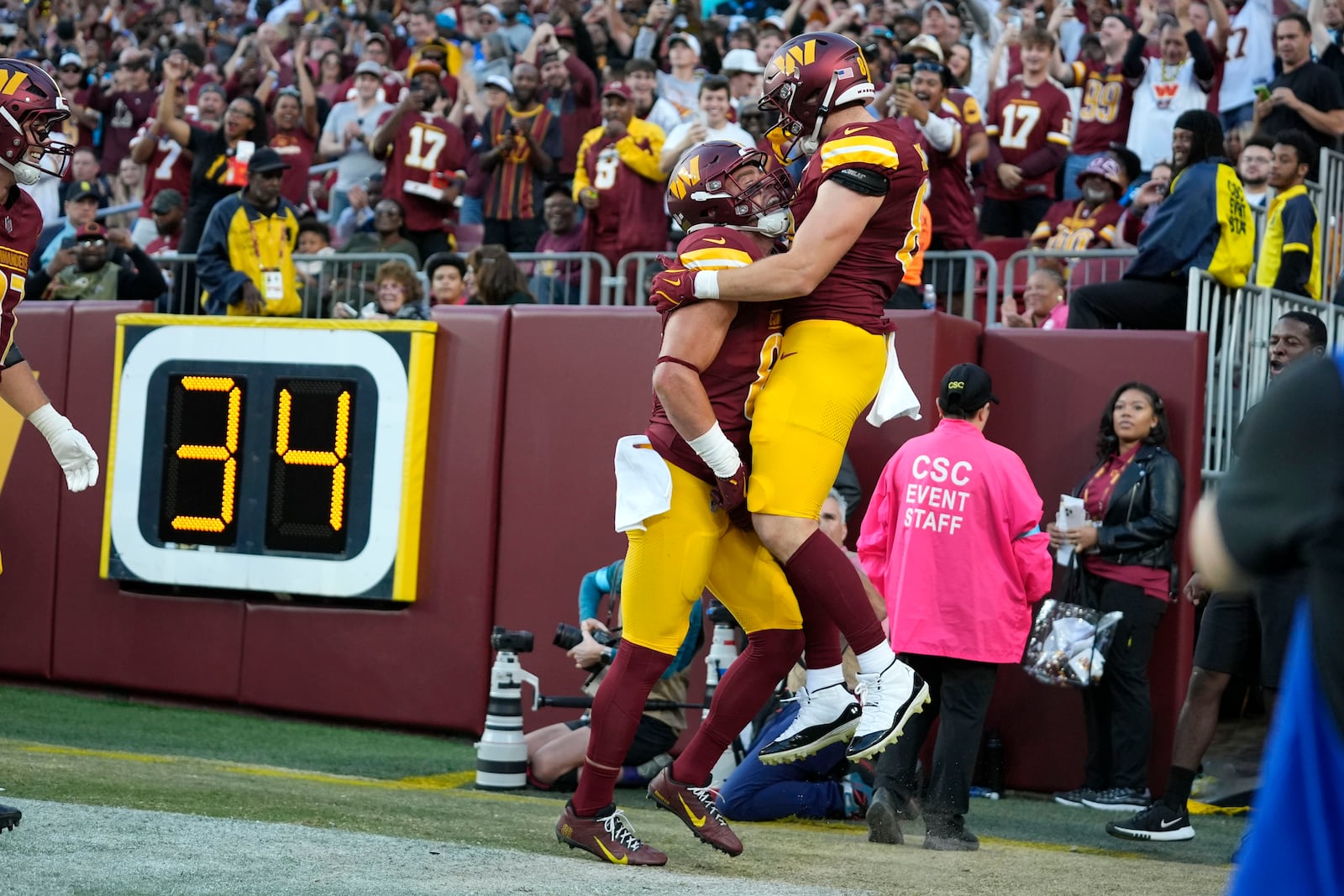 Washington Commanders tight end Ben Sinnott, right, celebrates after catching a 3-yard touchdown pass during the second half of an NFL football game against the Carolina Panthers, Sunday, Oct. 20, 2024, in Landover, Md. (AP Photo/Stephanie Scarbrough)