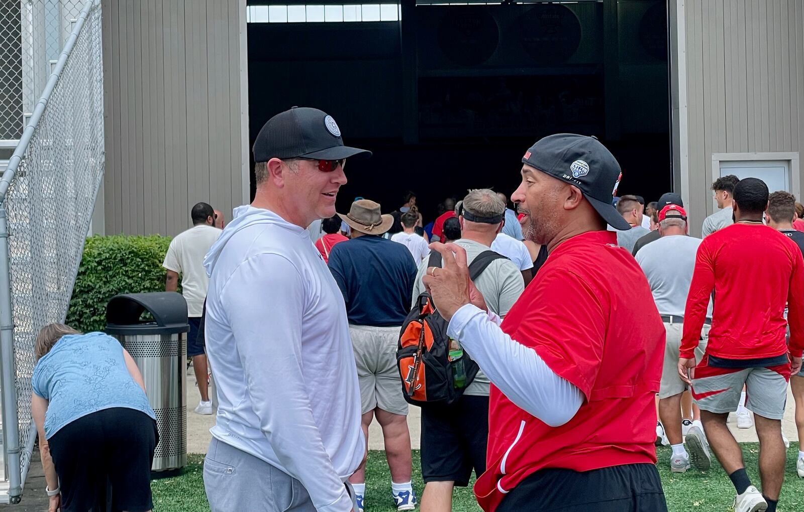 Former Ohio State quarterback Kirk Herbstreit speaks with teammate Tim Walton, who is in his first year on staff at Ohio State, during a camp day in Columbus June 14, 2022. (Photo: Marcus Hartman/STAFF)