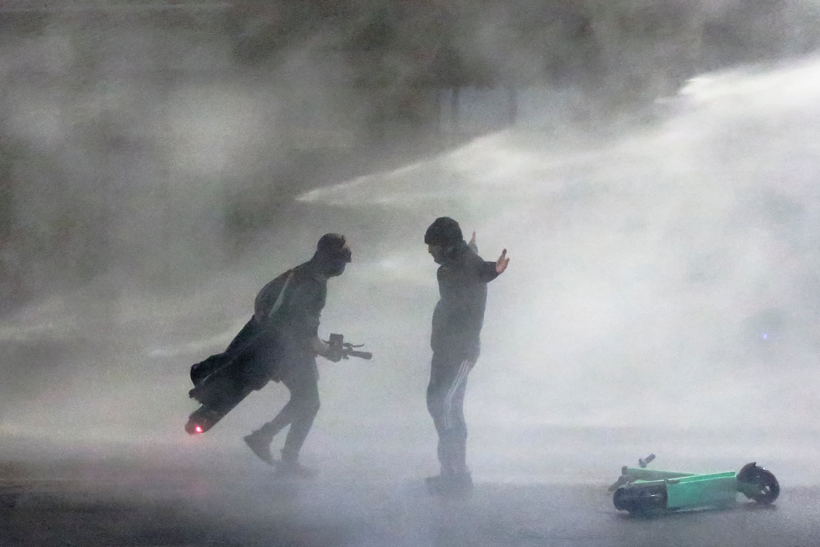 Police use a water cannon on protesters during a rally against the government's decision to suspend negotiations on joining the European Union for four years, outside the parliament's building in Tbilisi, Georgia, early Monday, Dec. 2, 2024. (AP Photo/Zurab Tsertsvadze)