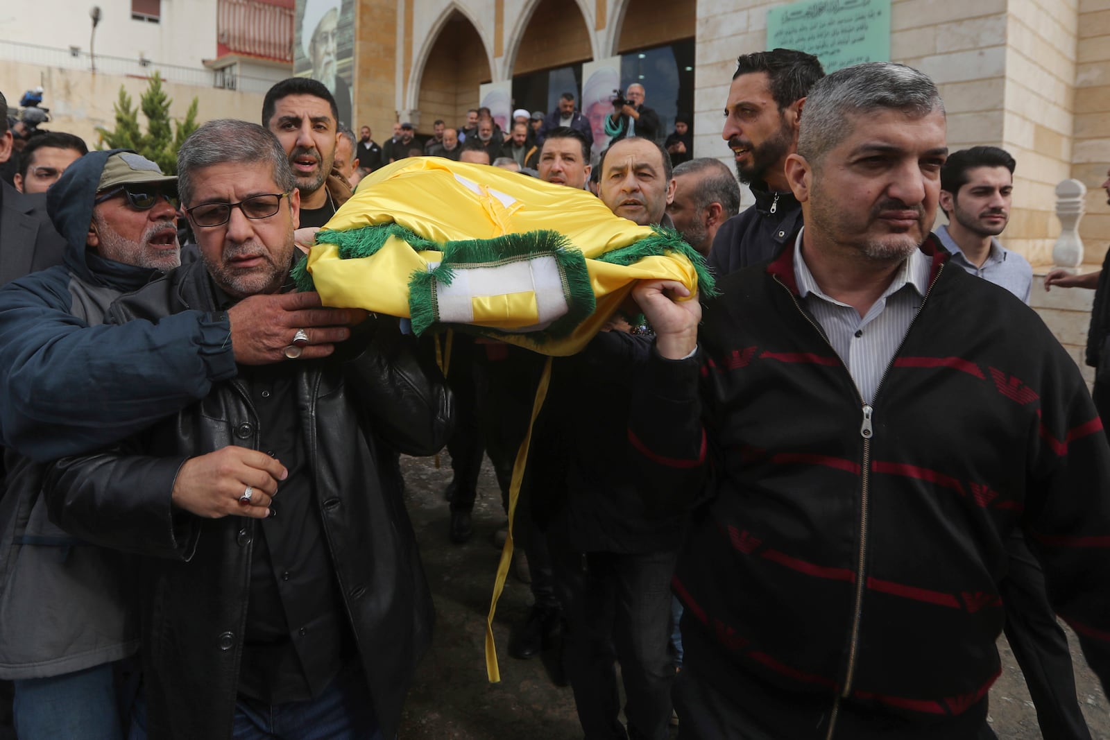 Mourners and relatives of Hezbollah's chief spokesman Mohammed Afif who was killed in an Israeli airstrike in Beirut on Sunday, carry his body during his funeral in the southern port city of Sidon, Lebanon, Monday, Nov. 18, 2024. (AP Photo/Mohammed Zaatari)