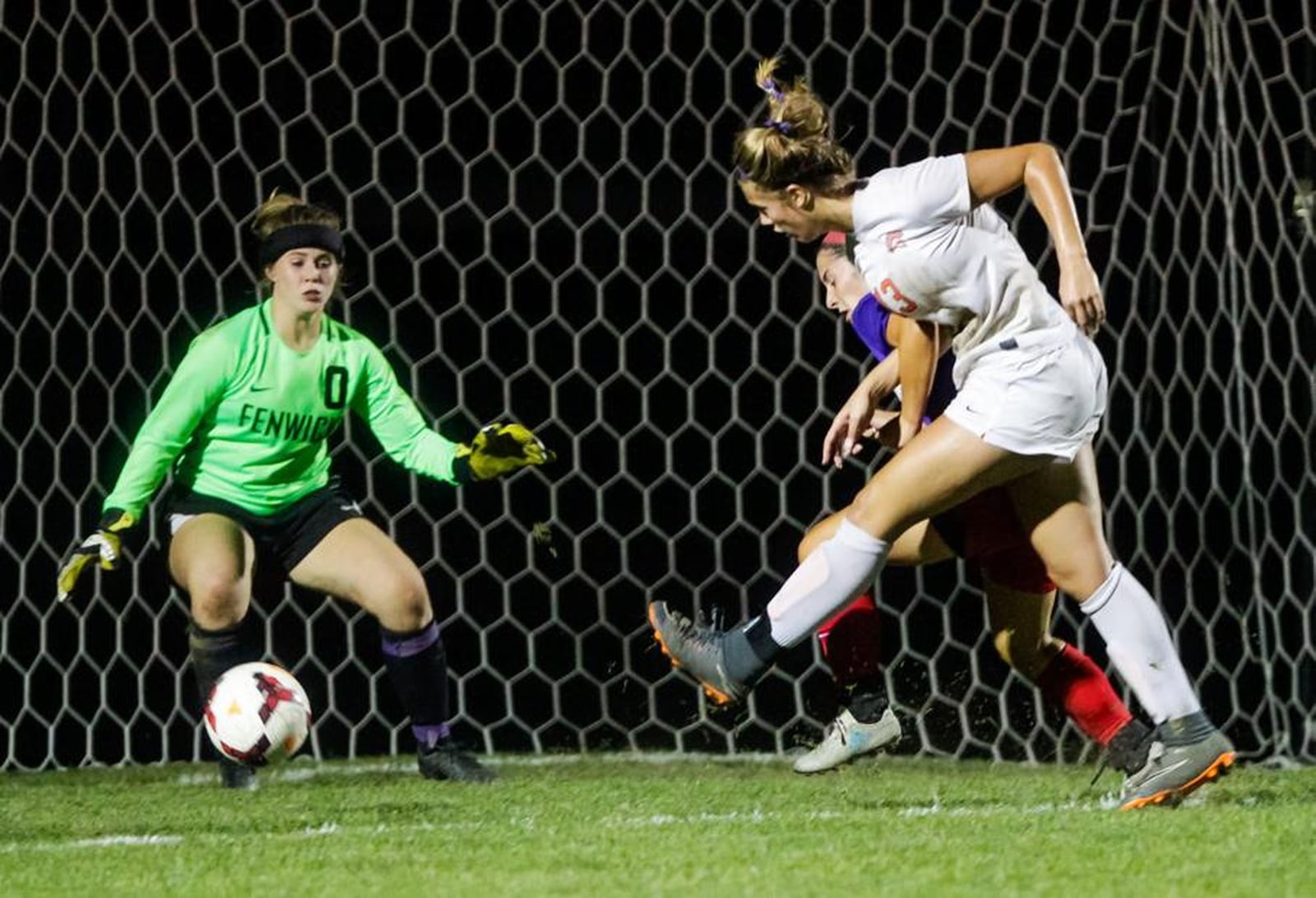 Waynesville’s Marcella Sizer (13) gets a shot off against Fenwick goalkeeper Harper Brock on Monday night at Fenwick. The host Falcons won 1-0. NICK GRAHAM/STAFF