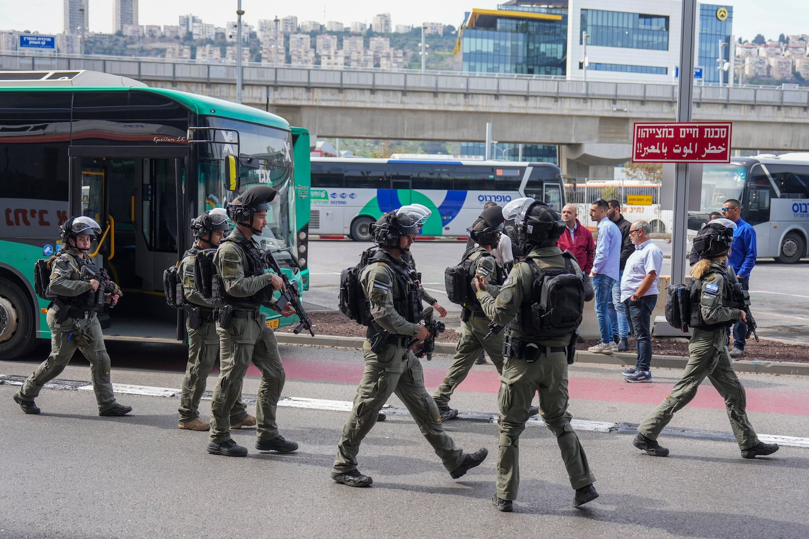 Israeli security forces secure the scene of a stabbing attack in Haifa, Israel, on Monday, March 30, 2025, where a 70-year-old man was killed and four others were injured. (AP Photo/Ariel Schalit)