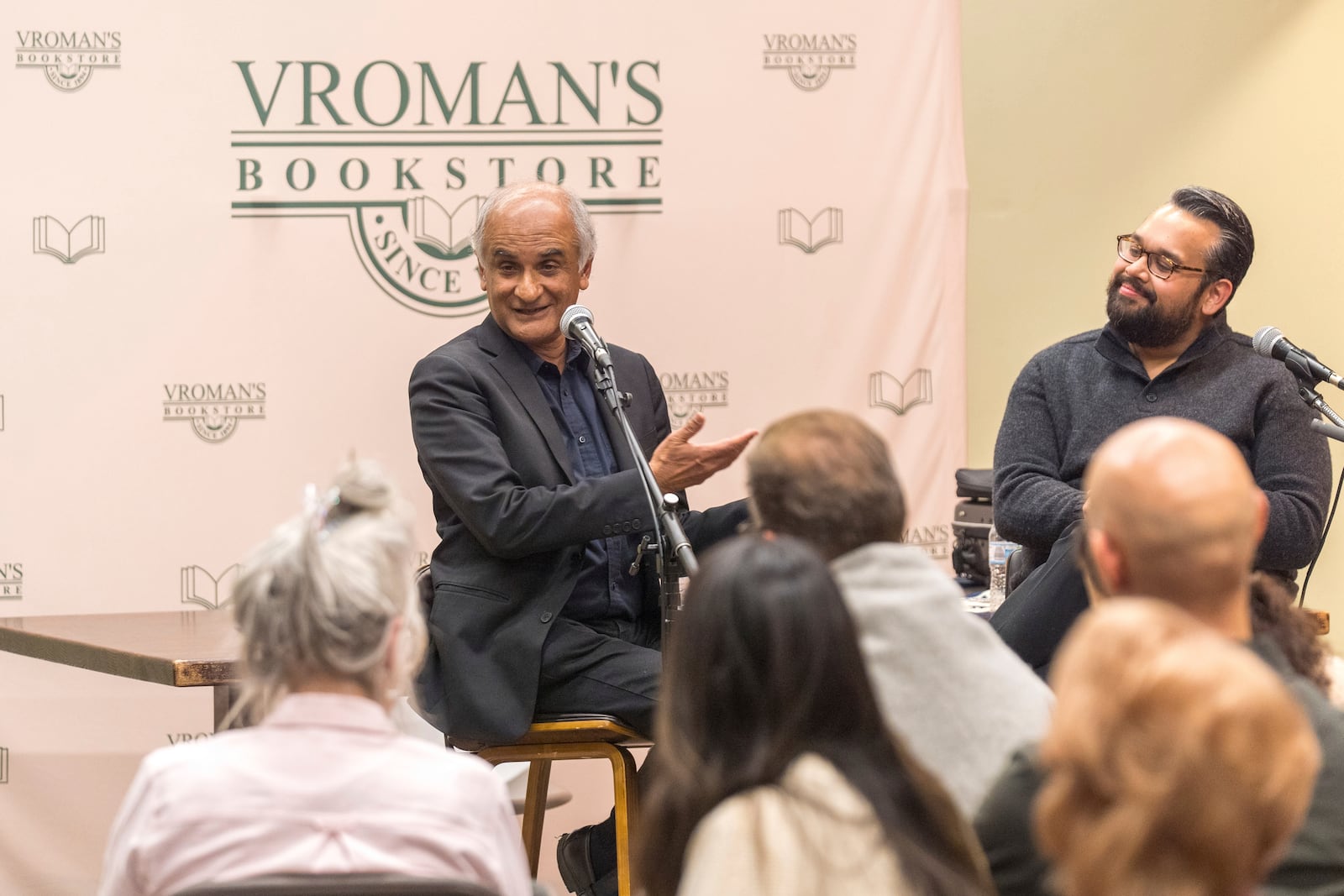 Violinist Vijay Gupta, right, introduces Pico Iyer, the bestselling author of "The Art of Stillness," during a presentation of Iyer's new book, "Aflame: Learning from Silence," at Vroman's bookstore in Pasadena, Calif., on Tuesday, Jan. 28, 2025, in the wake of the devastating Eaton Fire that recently swept through parts of Pasadena and Altadena, forcing over 30,000 people to evacuate and burning thousands of structures. (AP Photo/Damian Dovarganes)