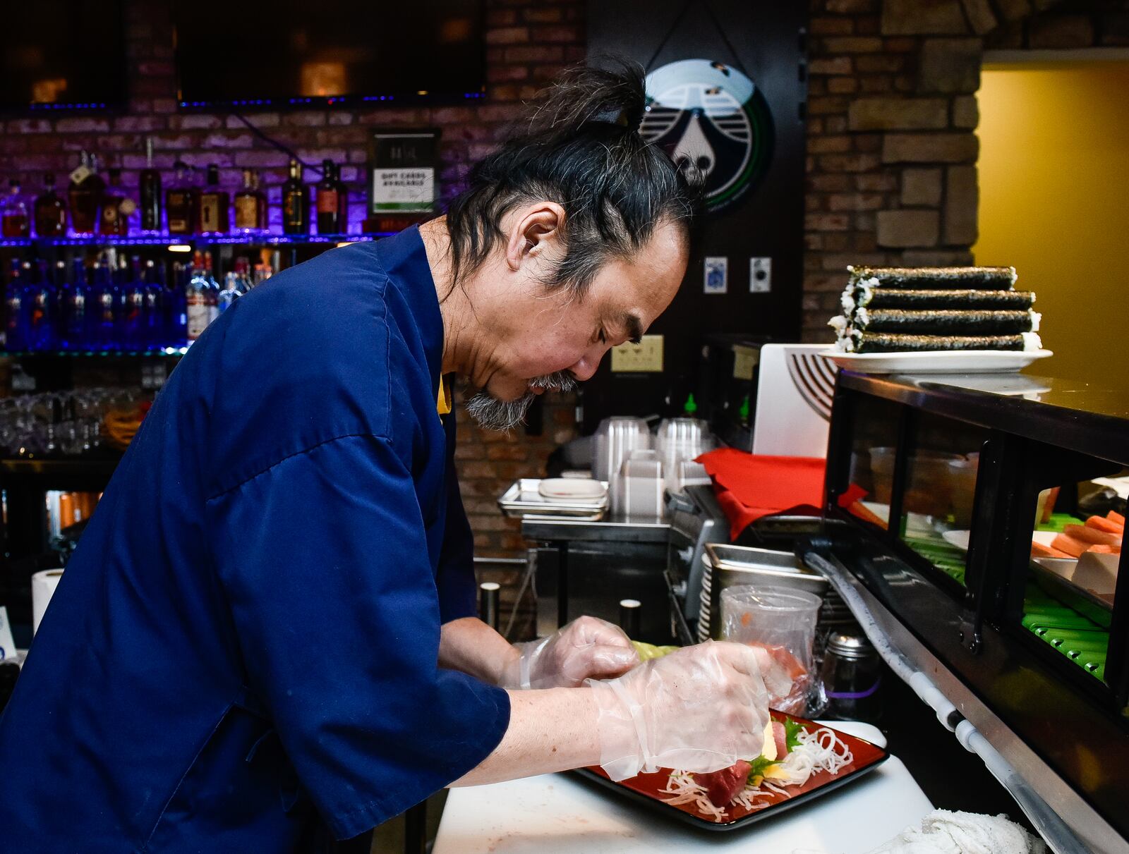 Sushi chef Ming prepares a Sushi and Sashimi sampler Wednesday, Jan. 17 at Basil 1791 that is now open on High Street in Hamilton. NICK GRAHAM/STAFF