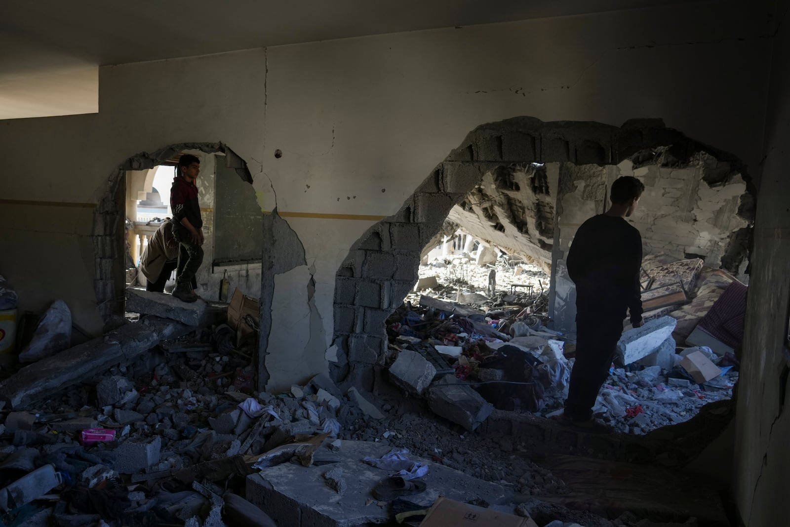 Palestinians inspect the damage at Al-Tabi'in School in central Gaza Strip following an Israeli airstrike, Tuesday, March 18, 2025. (AP Photo/Jehad Alshrafi)