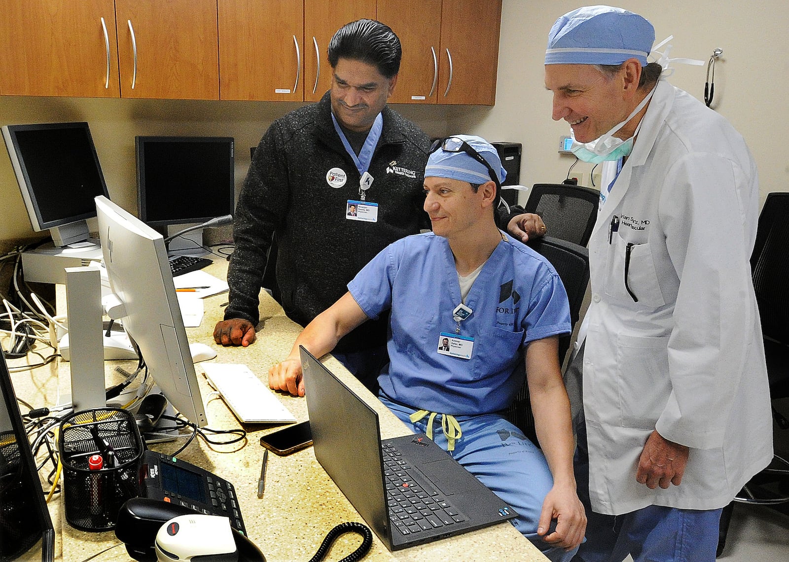 From left, Kettering Health cardiologists Dr. Niranjan Reddy, chief of interventional cardiology at Kettering Health; Dr. Ammar Safar, chief of cardiology at Kettering Health Main Campus; and Dr. Brian Schwartz, director for the heart and vascular service line at Kettering Health, use predictive software to analyze patient risks and reduce unwanted outcomes in cardiology. MARSHALL GORBY\STAFF